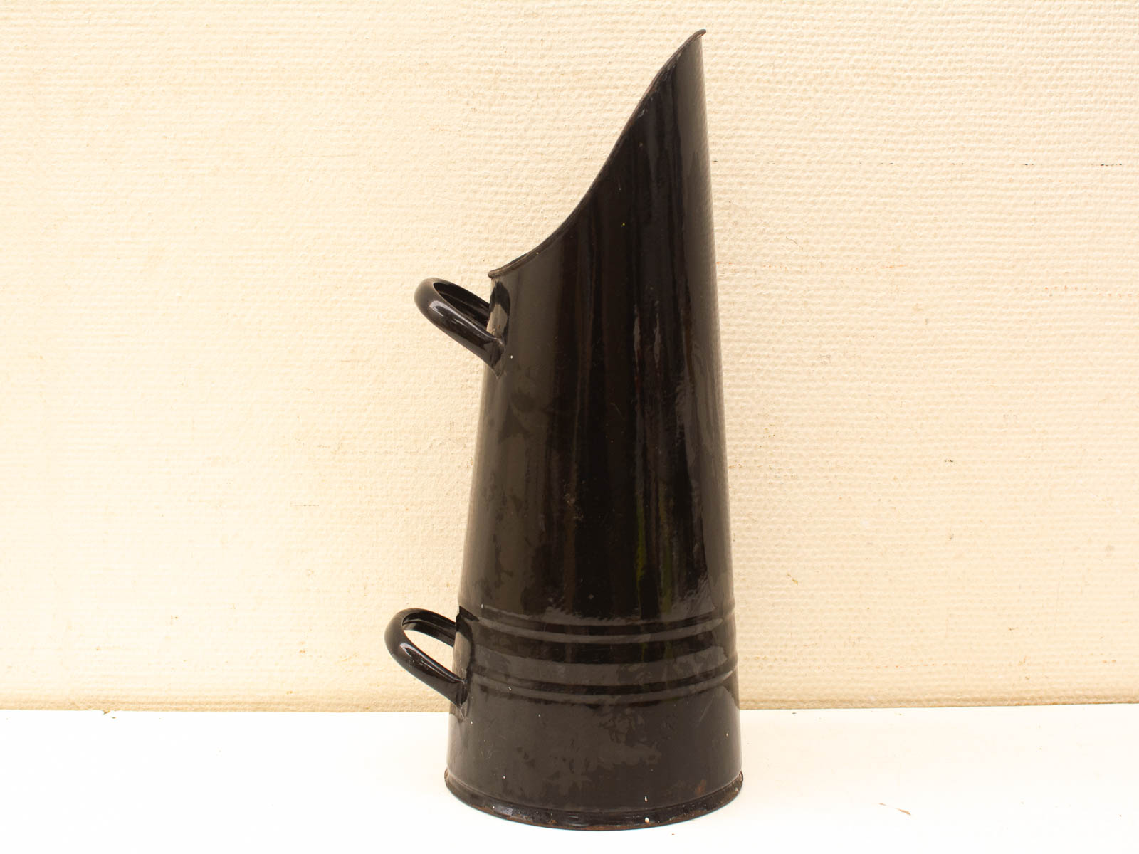 Elegant vintage black metal jug with conical shape, glossy finish, and practical handles.