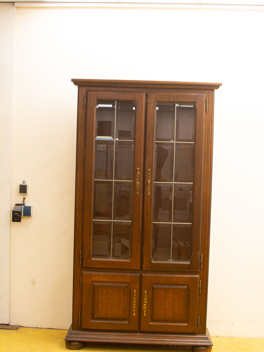 Vintage Dark Wood Glass Cabinet, Ideal for Displaying Collectibles with Gold-Tone Accents.