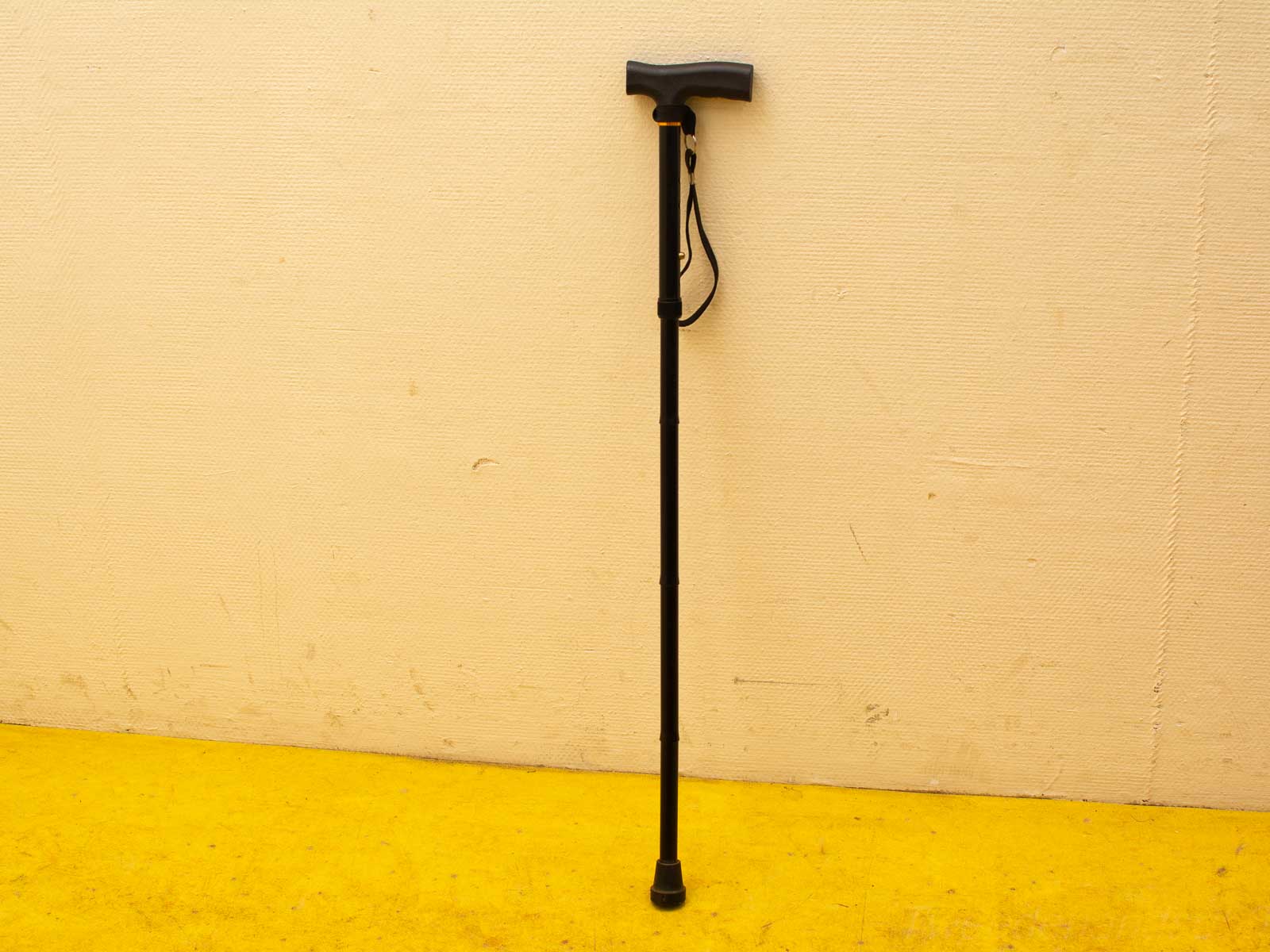 Adjustable black walking cane with ergonomic handle for comfort and enhanced mobility.