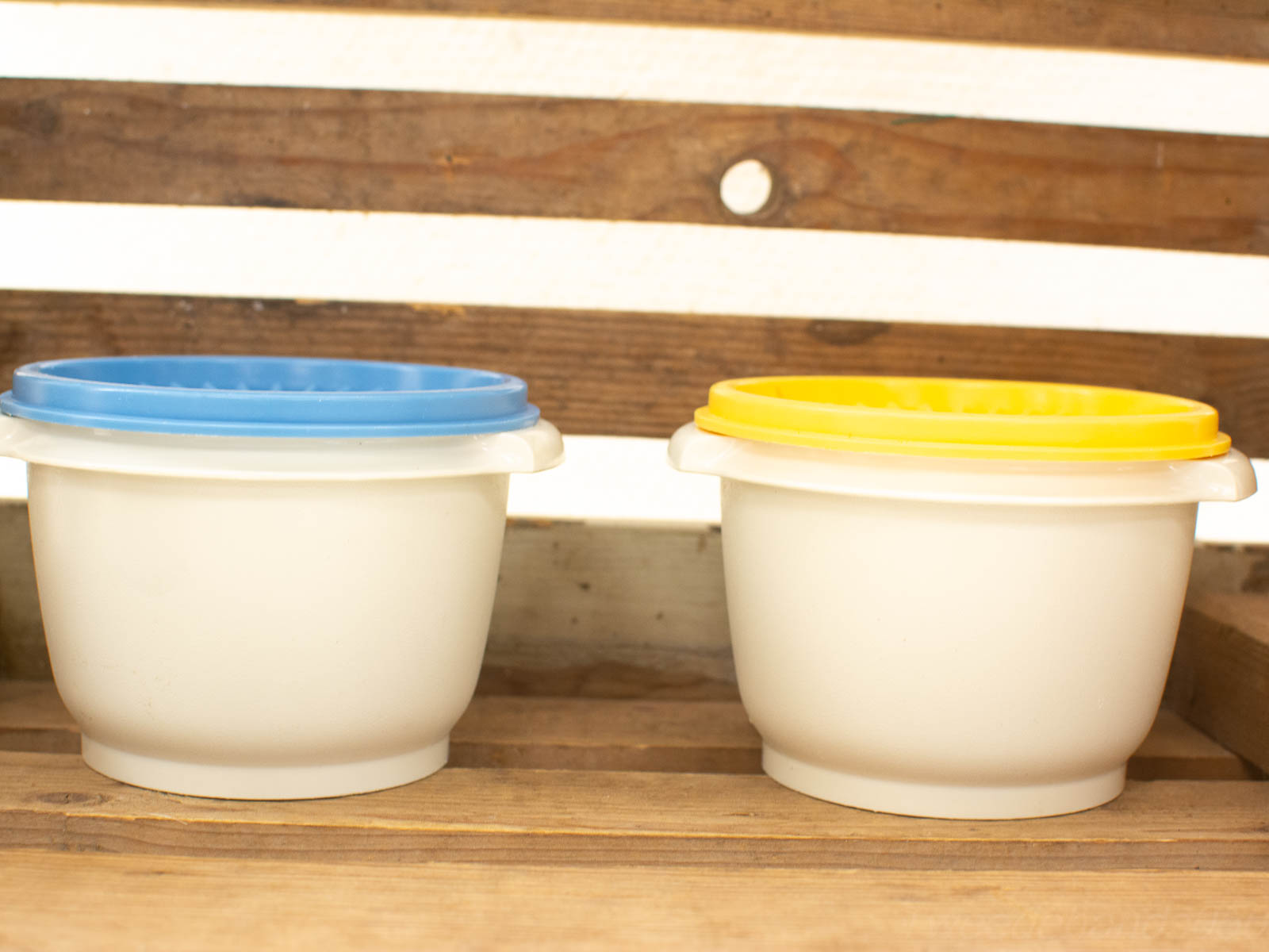 Vibrant white bowls with blue and yellow lids, perfect for stylish kitchen storage.