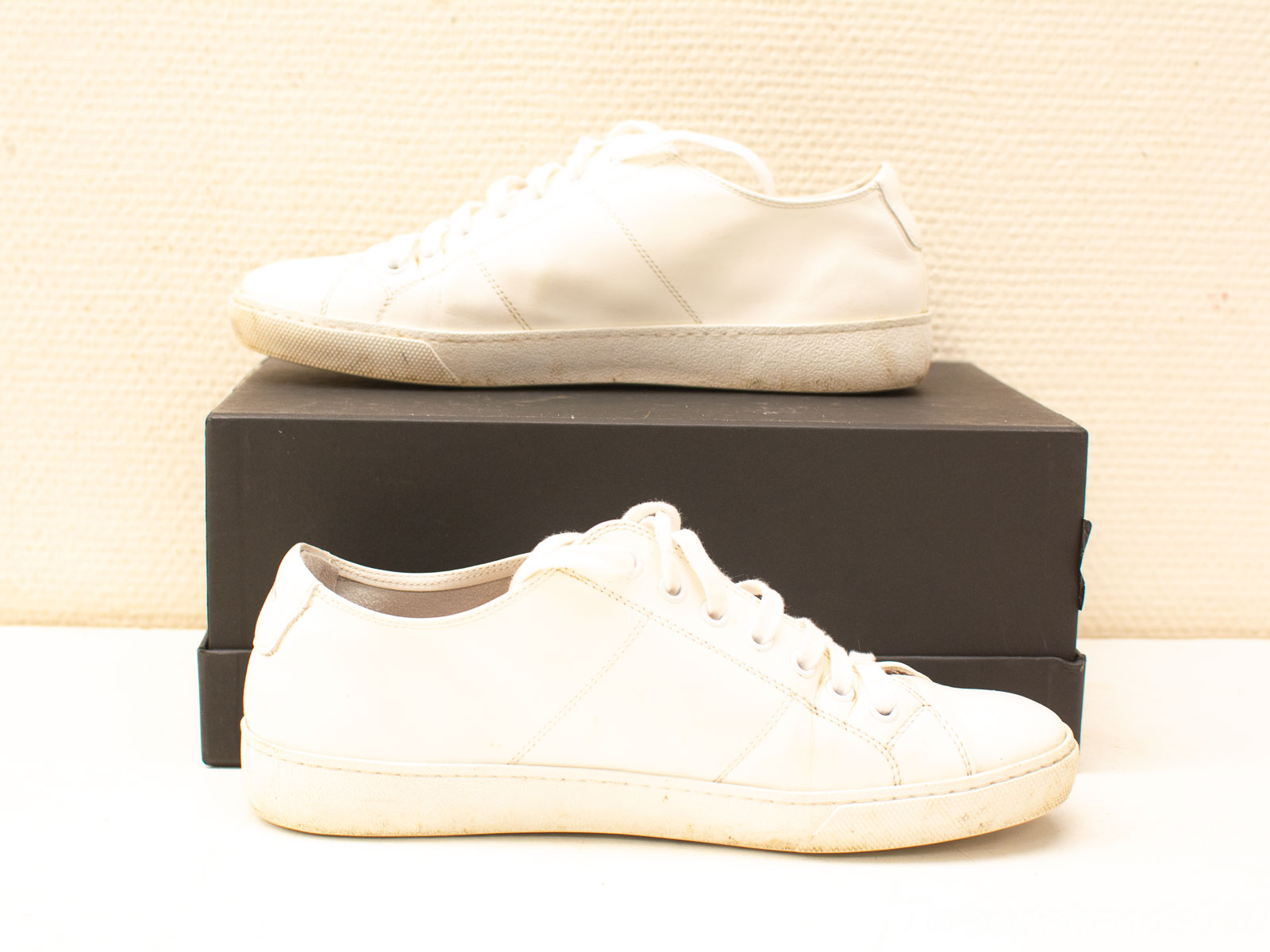 Contrasting white sneakers: new and worn, showcasing the journey of everyday footwear.