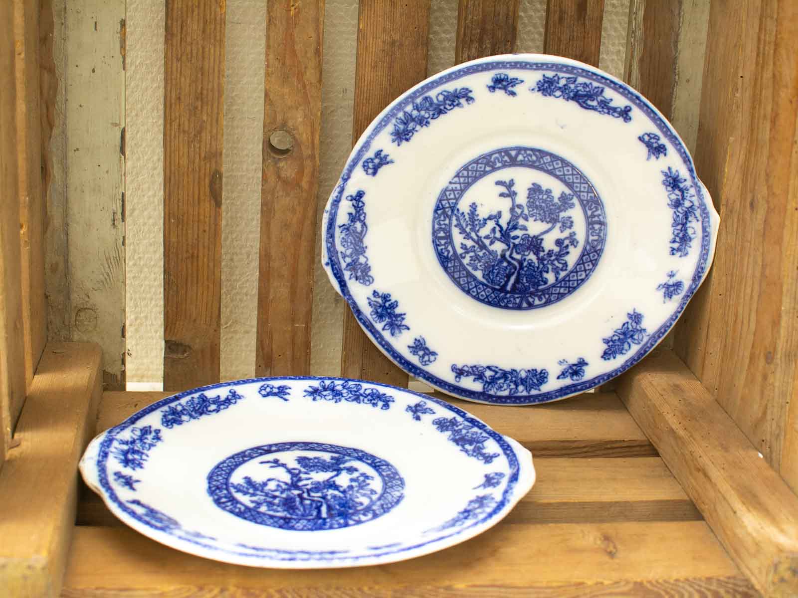 Elegant blue and white porcelain plates in a rustic wooden crate, showcasing timeless craftsmanship.