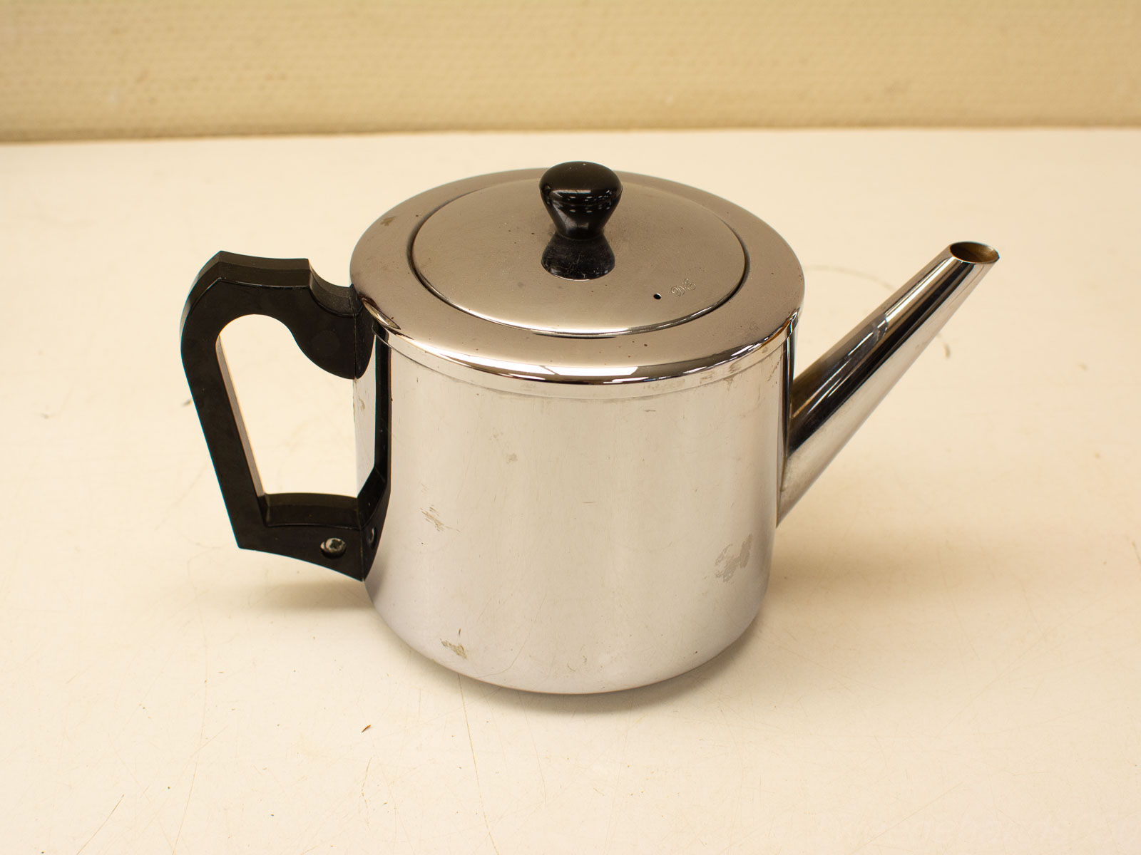 Elegant vintage stainless steel teapot, perfect for tea gatherings with a timeless charm.