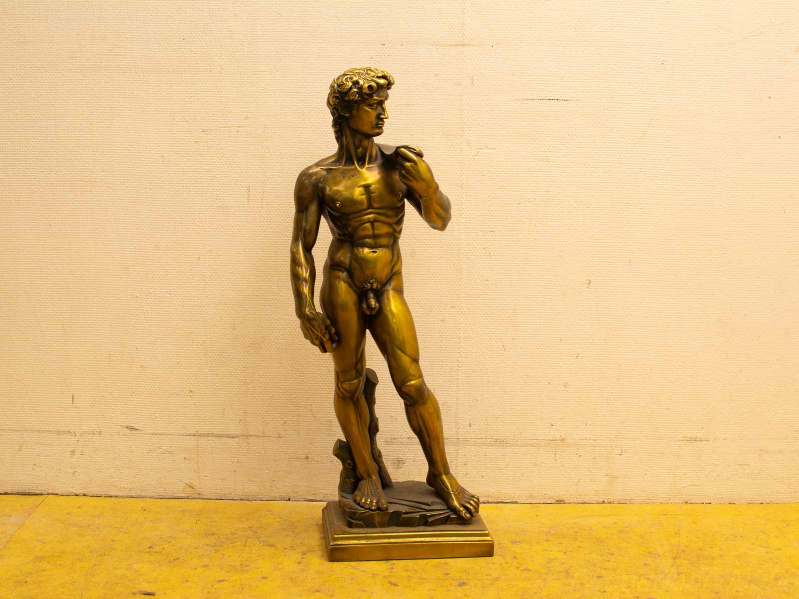 Bronze statue of a muscular male figure, showcasing classical artistry and exquisite craftsmanship.