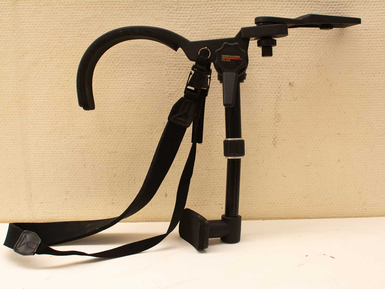 Professional camera support system with adjustable height and grip for stable photography.