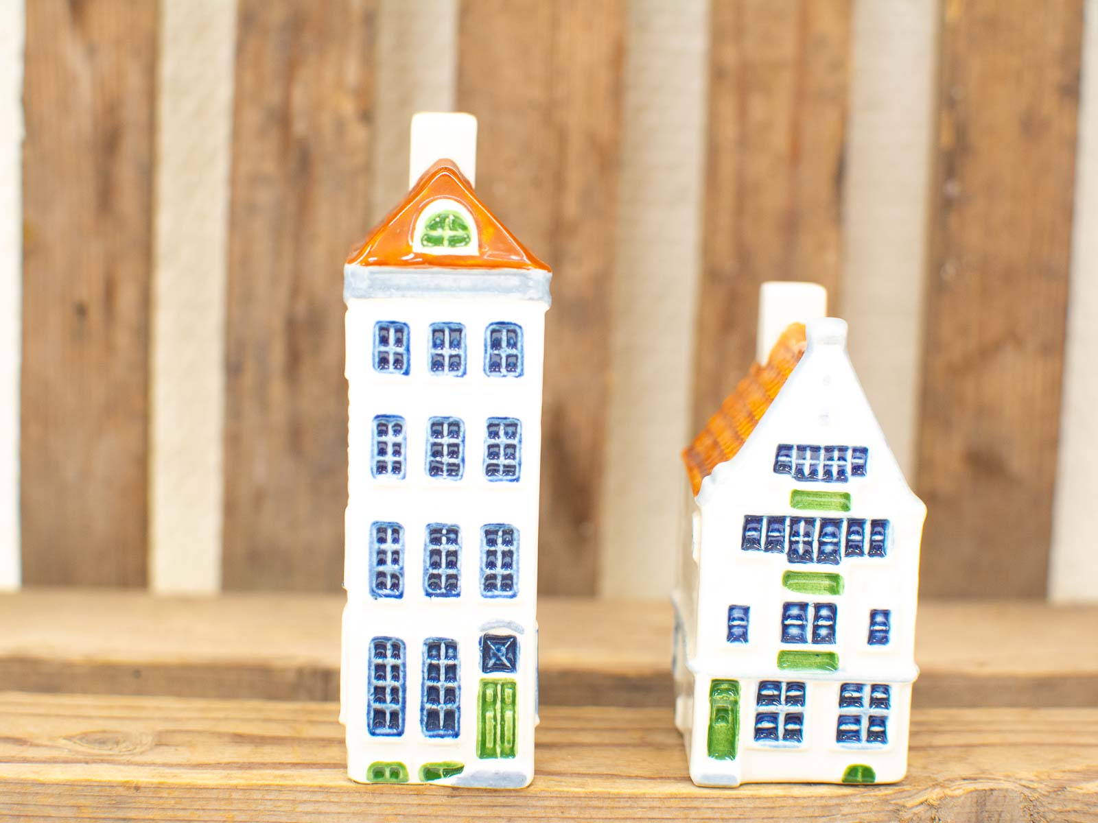 Charming vintage ceramic house figurines, perfect for collectors and whimsical home decor accents.