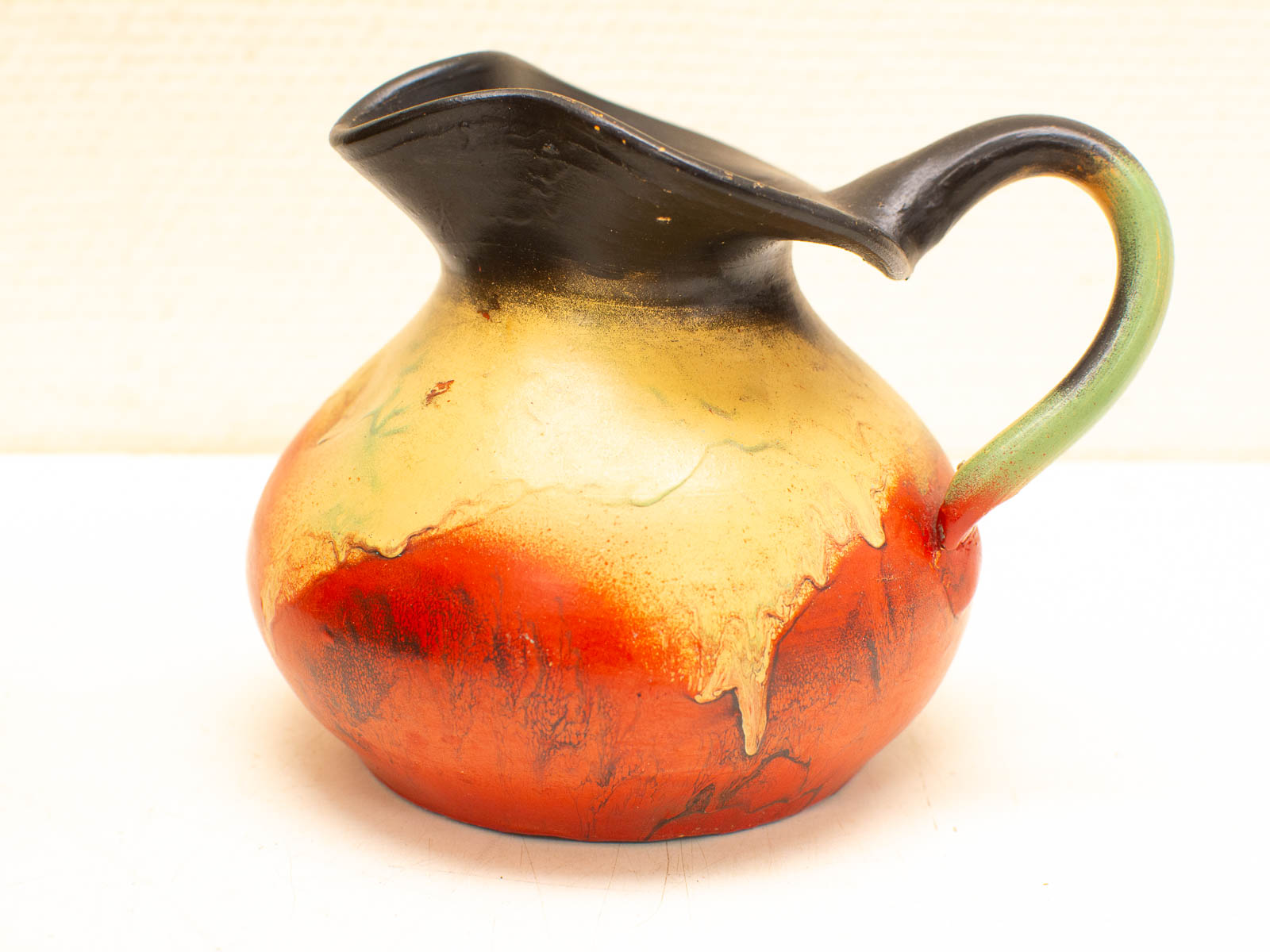 Vibrant ceramic pitcher with elegant curves and artistic design, perfect for decor or practical use.