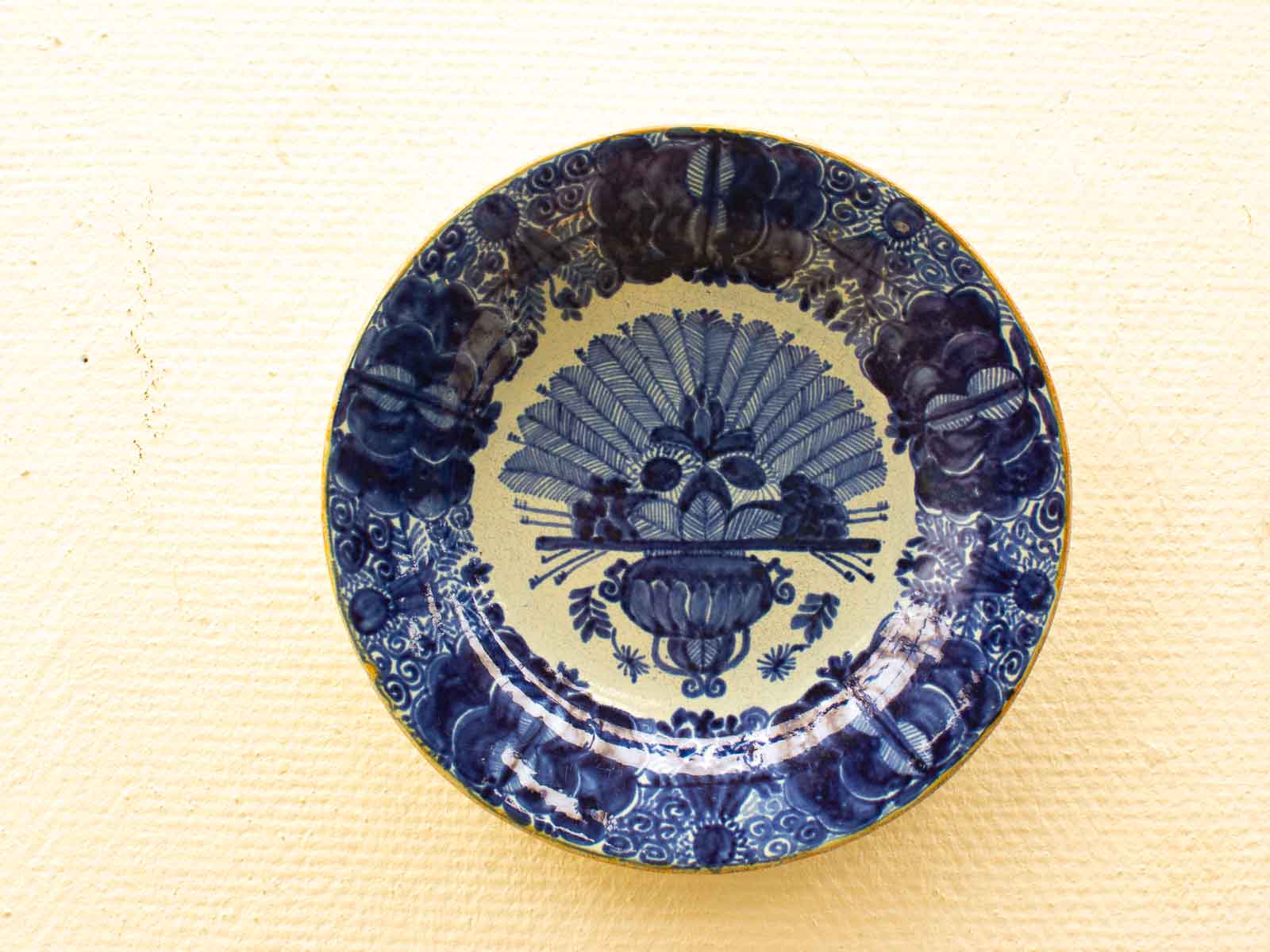 Elegant vintage blue-and-white ceramic plate with intricate designs for display or serving.