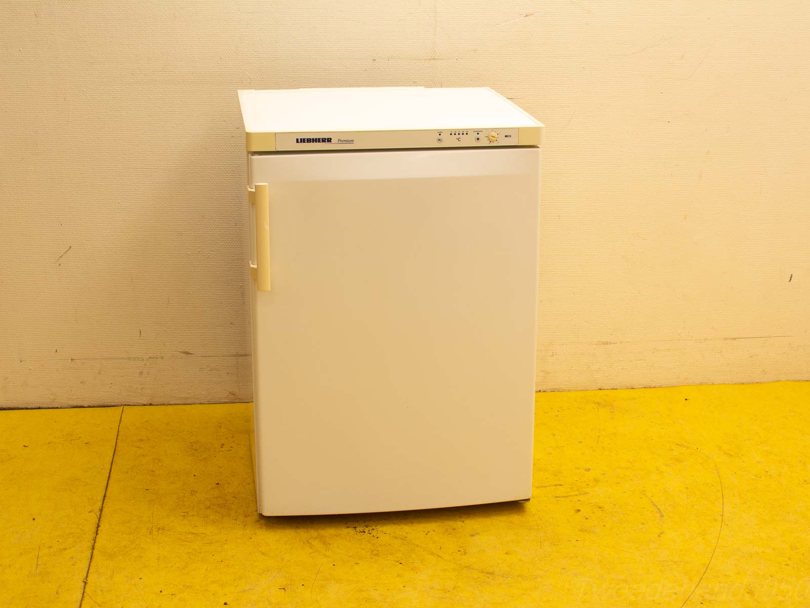 Compact white refrigerator with handle, ideal for small spaces like apartments and dorm rooms.