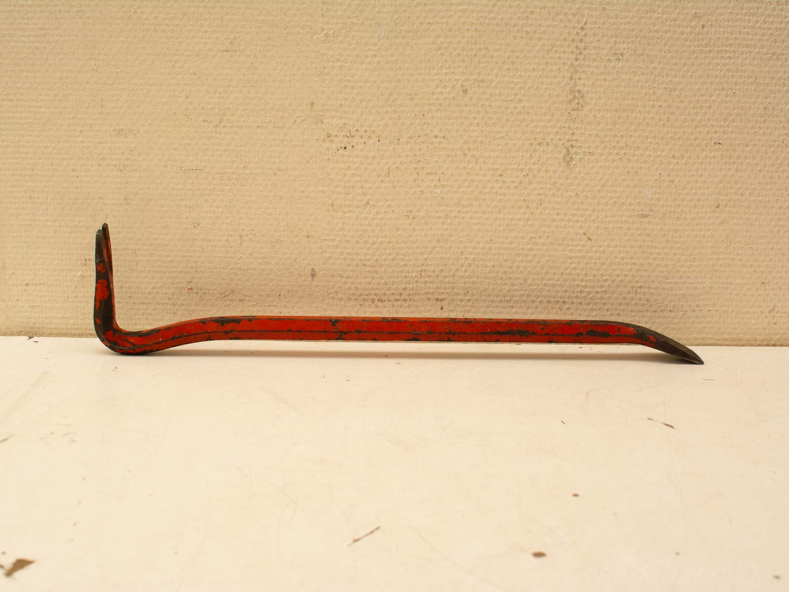 Vintage red crowbar, a versatile tool with character for prying, lifting, and demolition tasks.