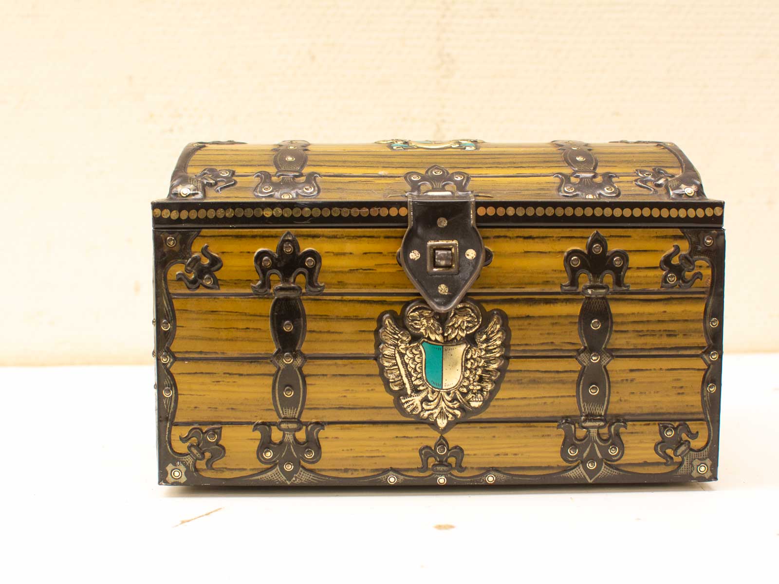 Antique wooden chest with intricate metalwork, perfect for storage or decorative display.