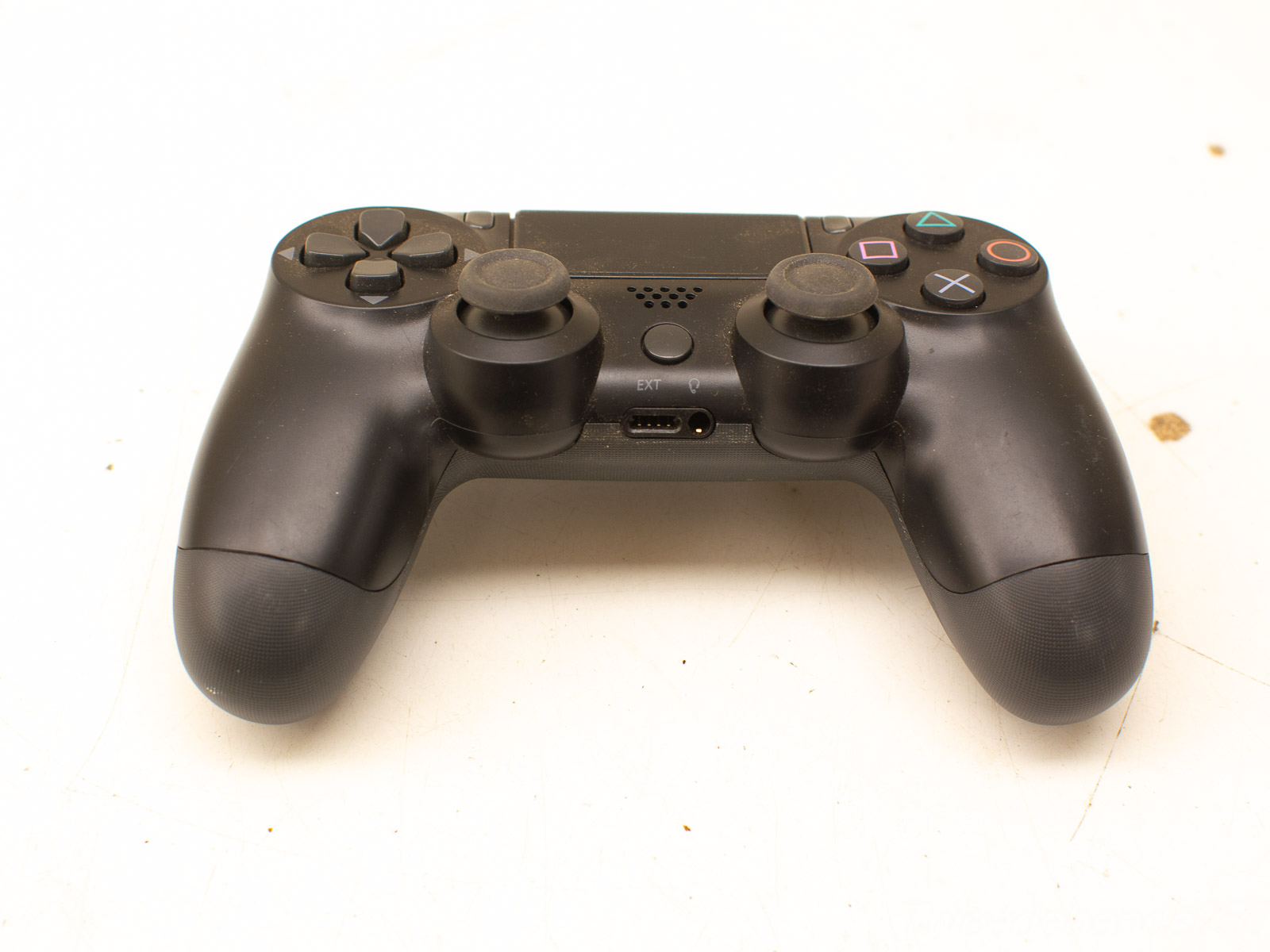 Pre-owned black DualShock 4 controller for immersive PlayStation 4 gaming experiences.