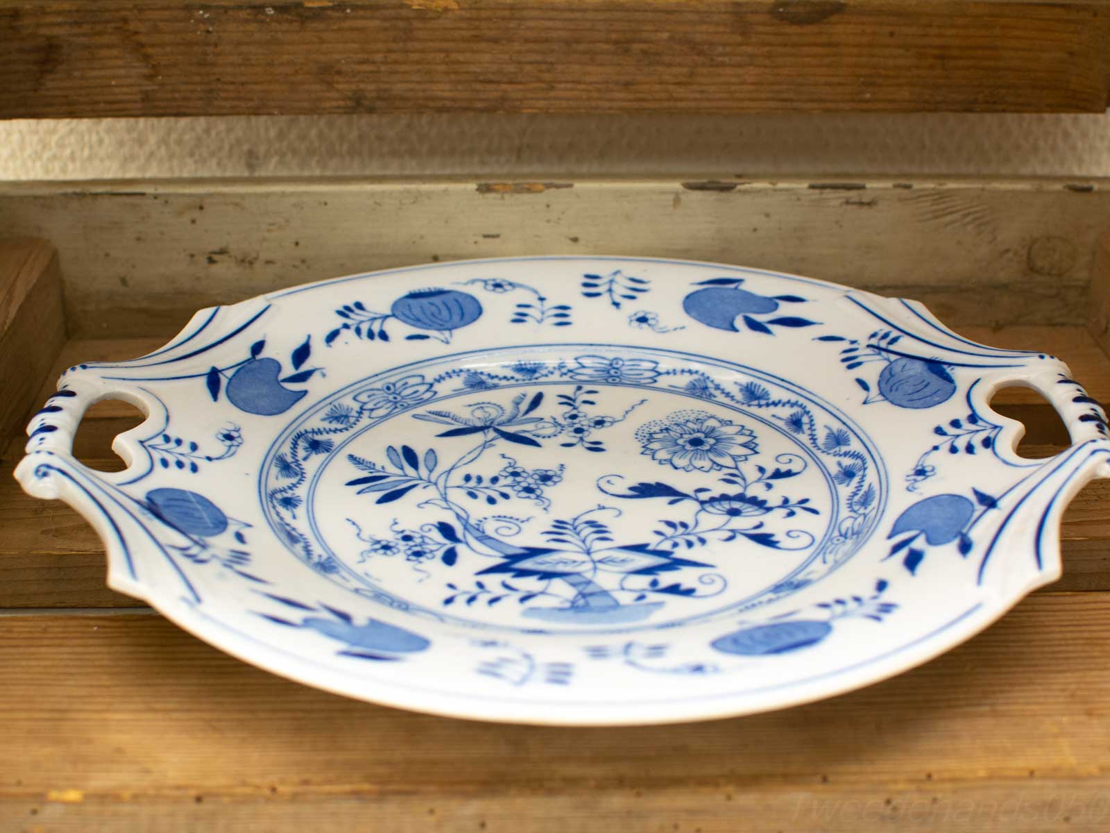 Elegant vintage ceramic platter with intricate blue floral designs on white background.