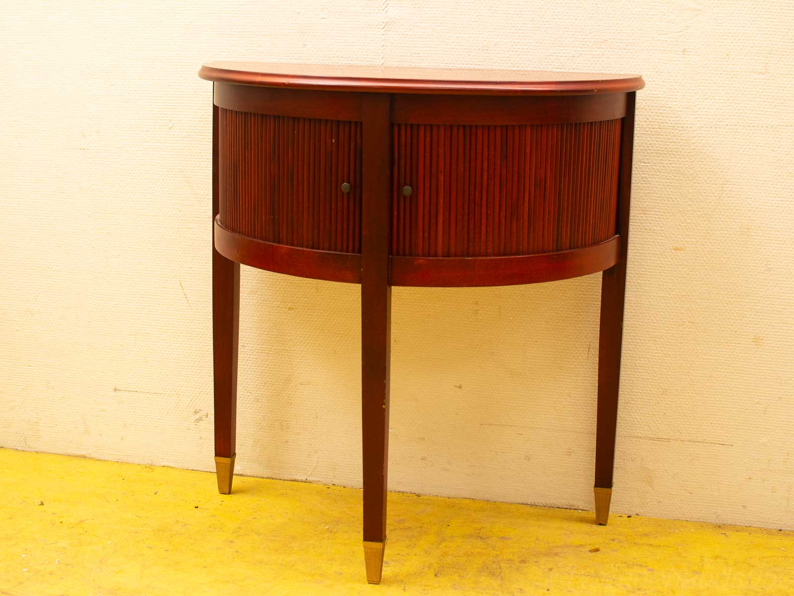 Elegant semi-circular console table in dark wood with ribbed details and tapered legs.