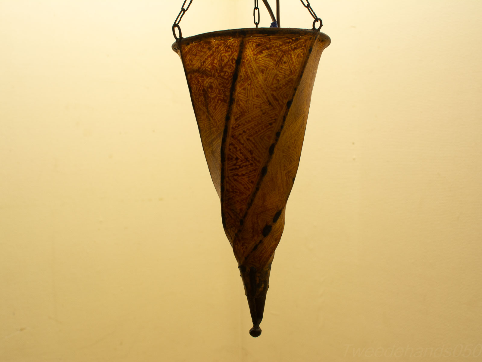 Elegant artisan amber hanging lamp with intricate patterns, perfect for enhancing any decor style.