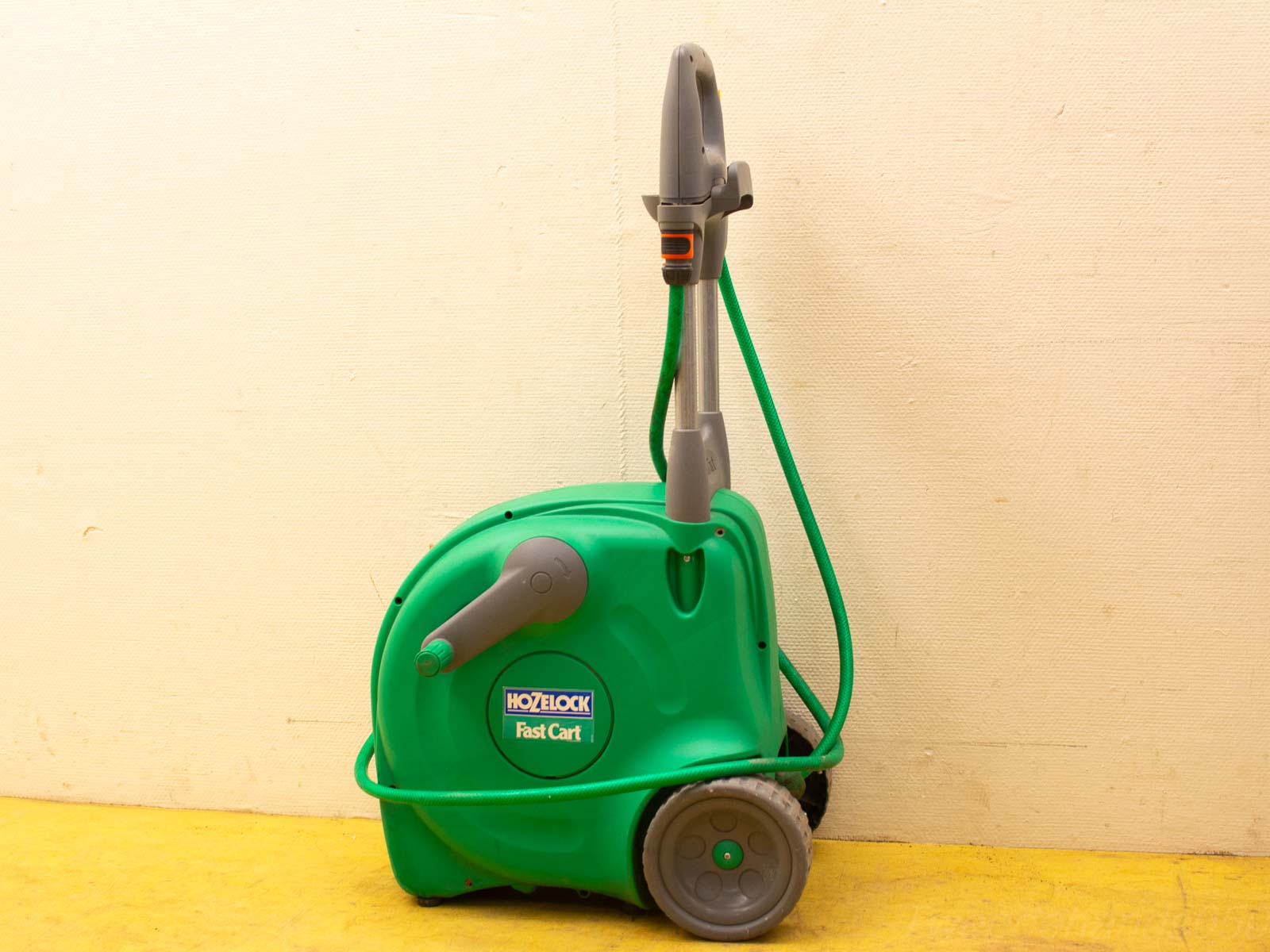 Compact Hozelock Fast Cart for easy hose storage and transport in vibrant green design.