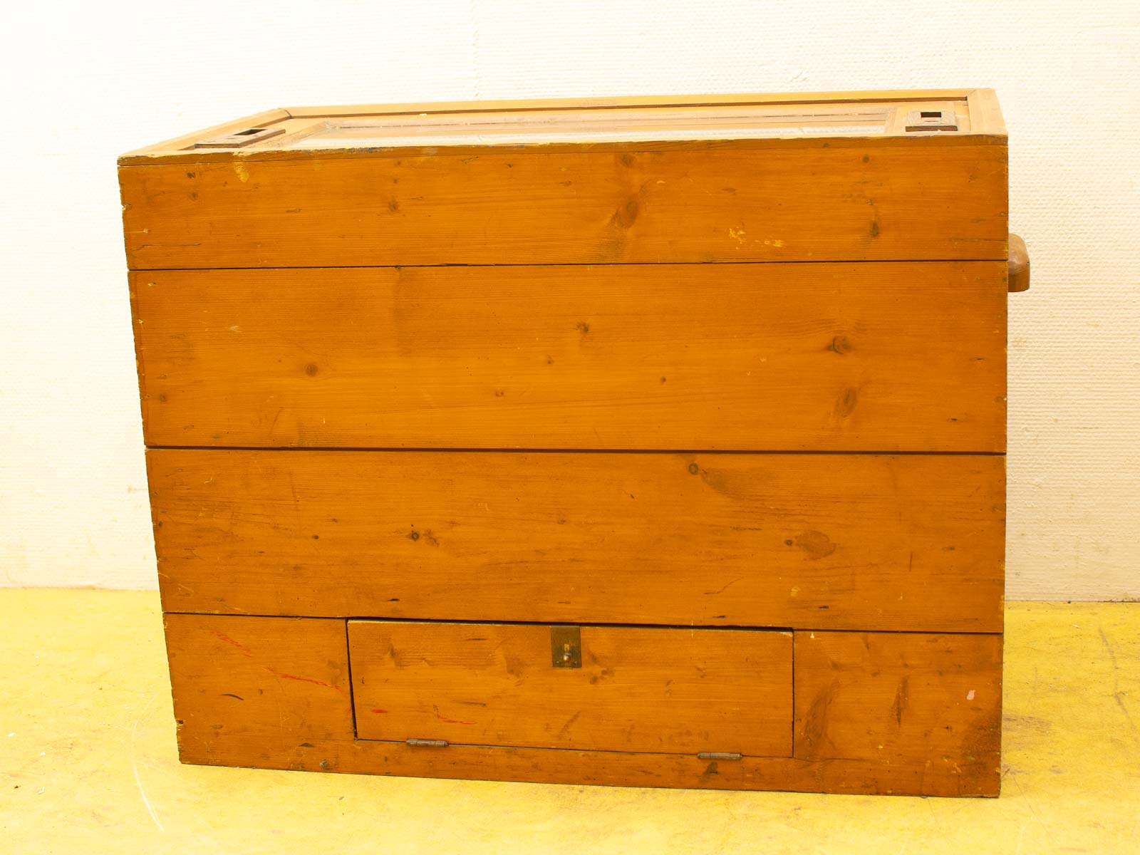 Vintage wooden cabinet with glass panel, drawer, and rustic charm for stylish display and storage.