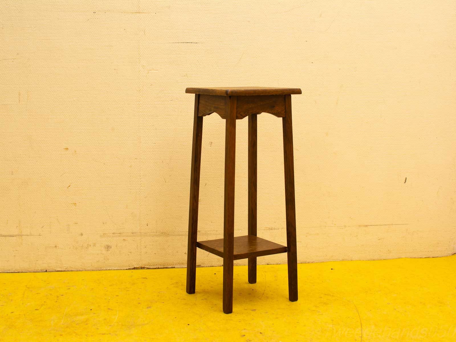 Elegant dark wood side table with lower shelf and decorative cutout edges for versatile decor.