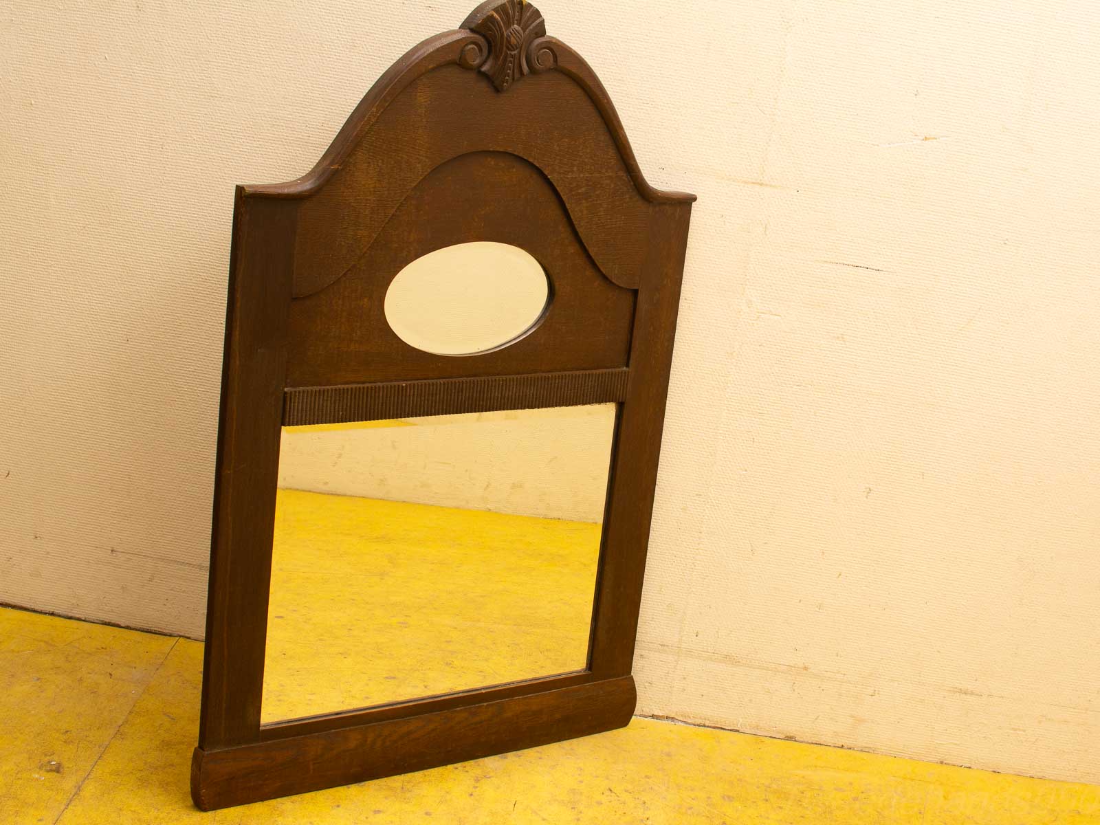 Elegant wooden mirror with intricate carvings and a decorative crest, perfect for any interior.