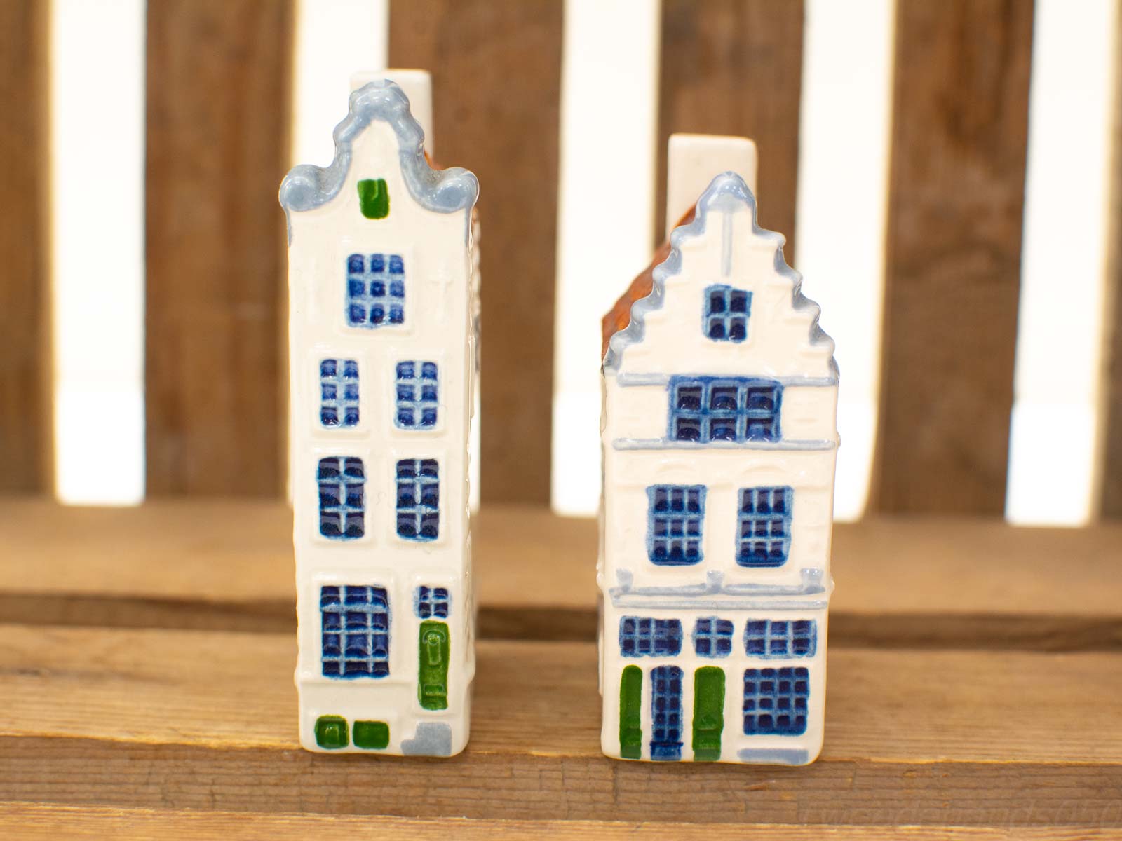 Charming vintage ceramic Dutch house figurines with blue accents, perfect for decor and collections.