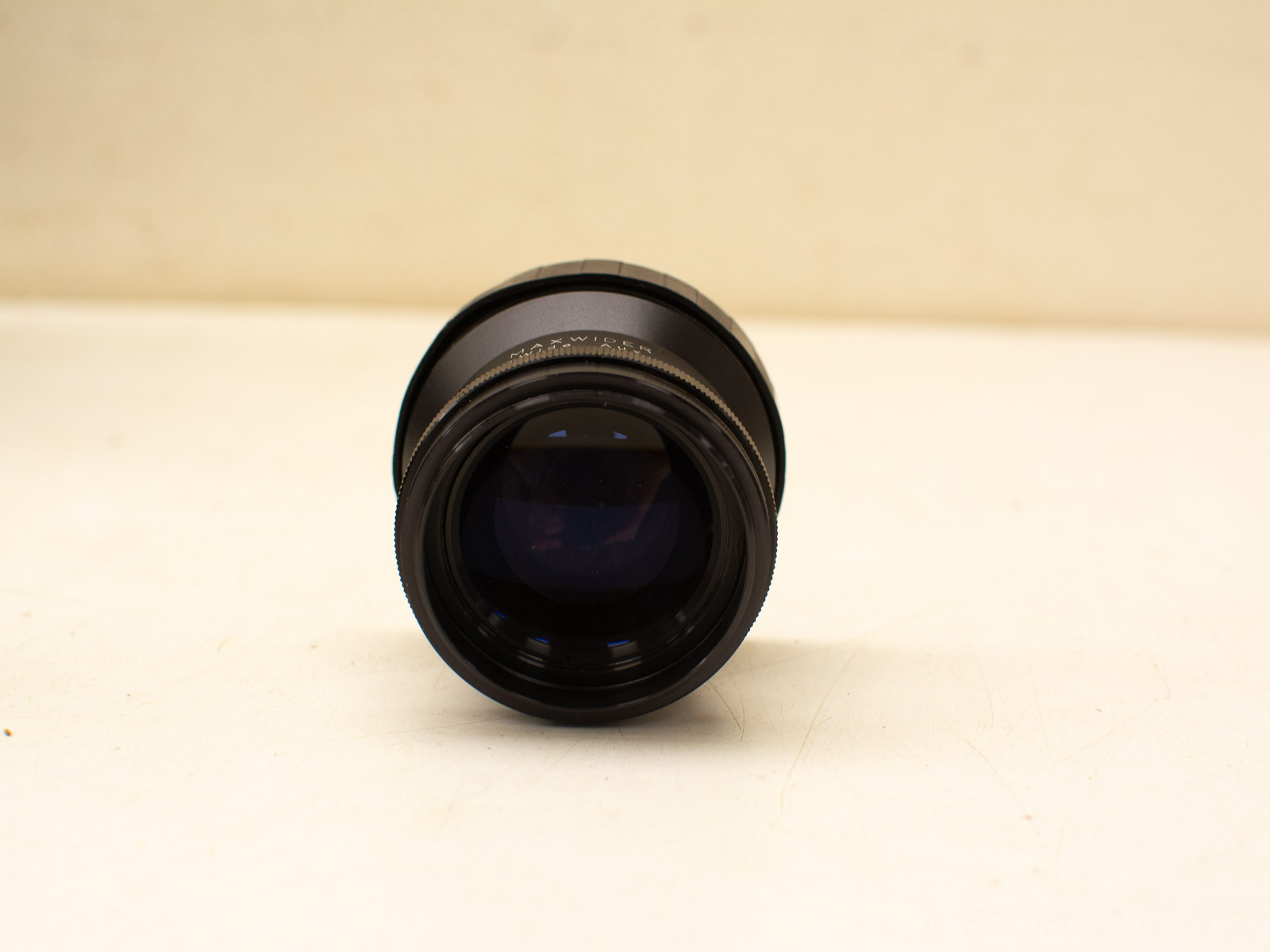 High-quality vintage camera lens with sleek black design and precise engravings in excellent condition.