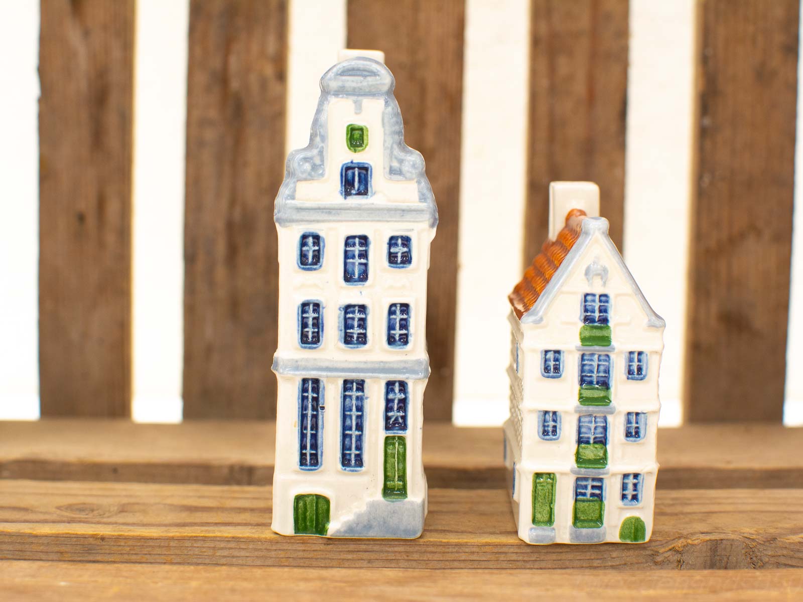 Charming vintage ceramic houses with green accents, perfect for nostalgic decor.