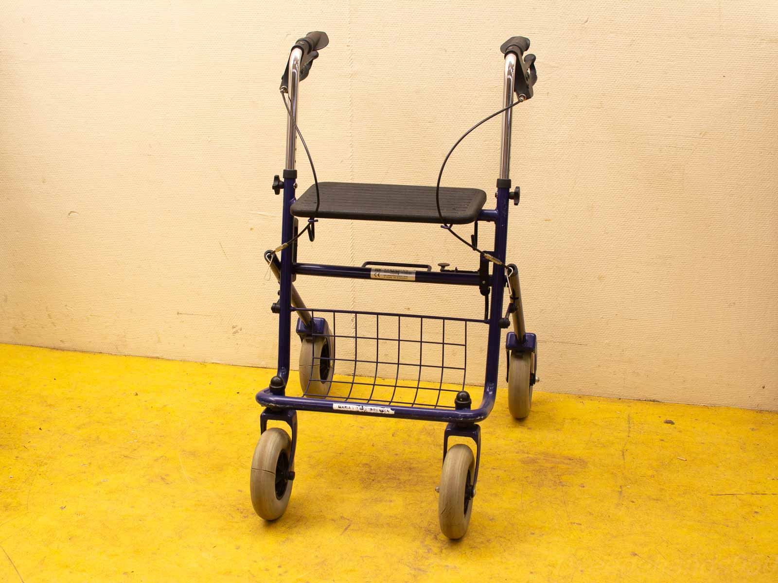 Vibrant blue walker with seat and basket, enhancing mobility and independence for users.