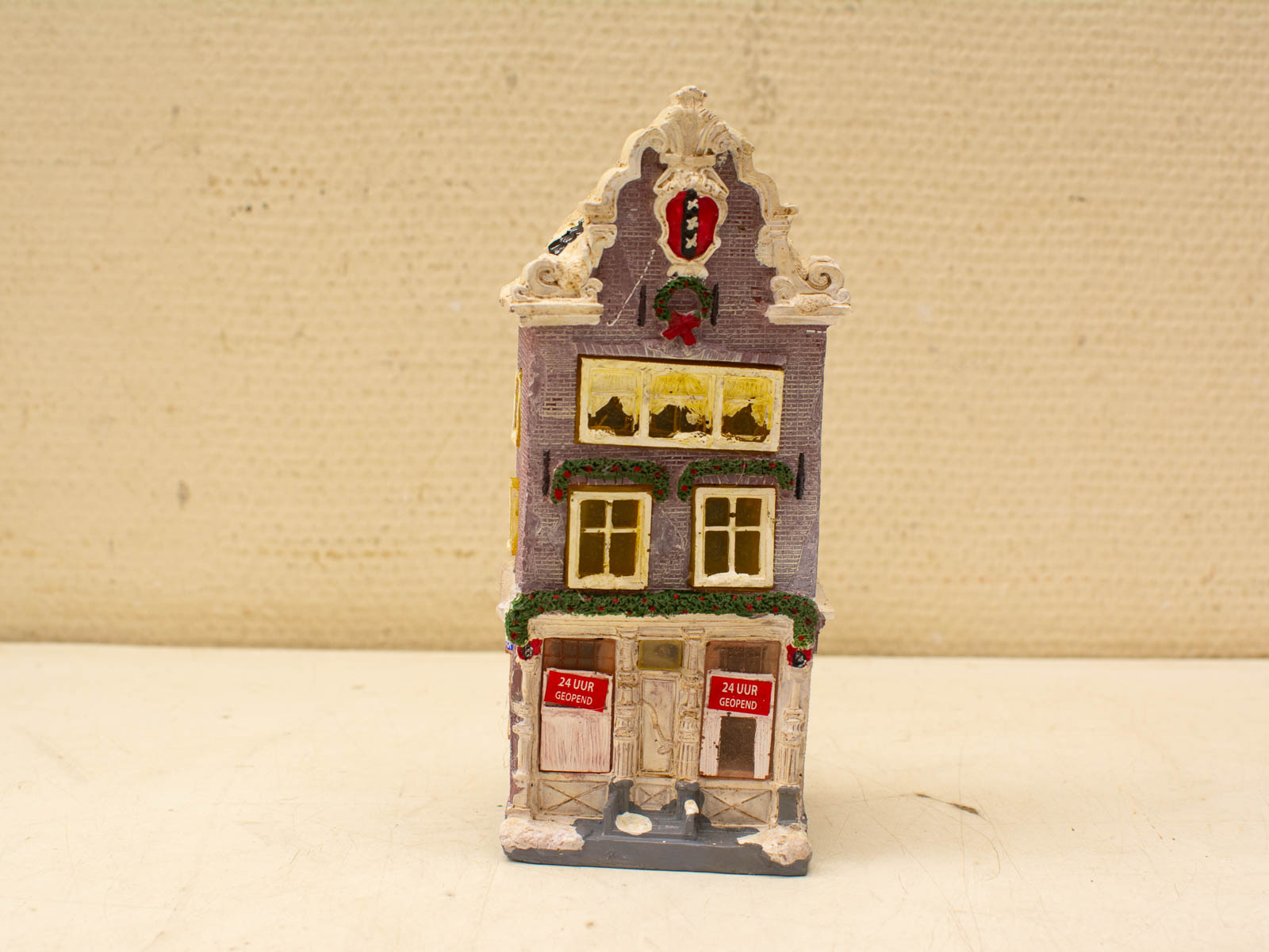 Whimsical miniature European building model, 24 hours open, charming light purple façade and intricate details.