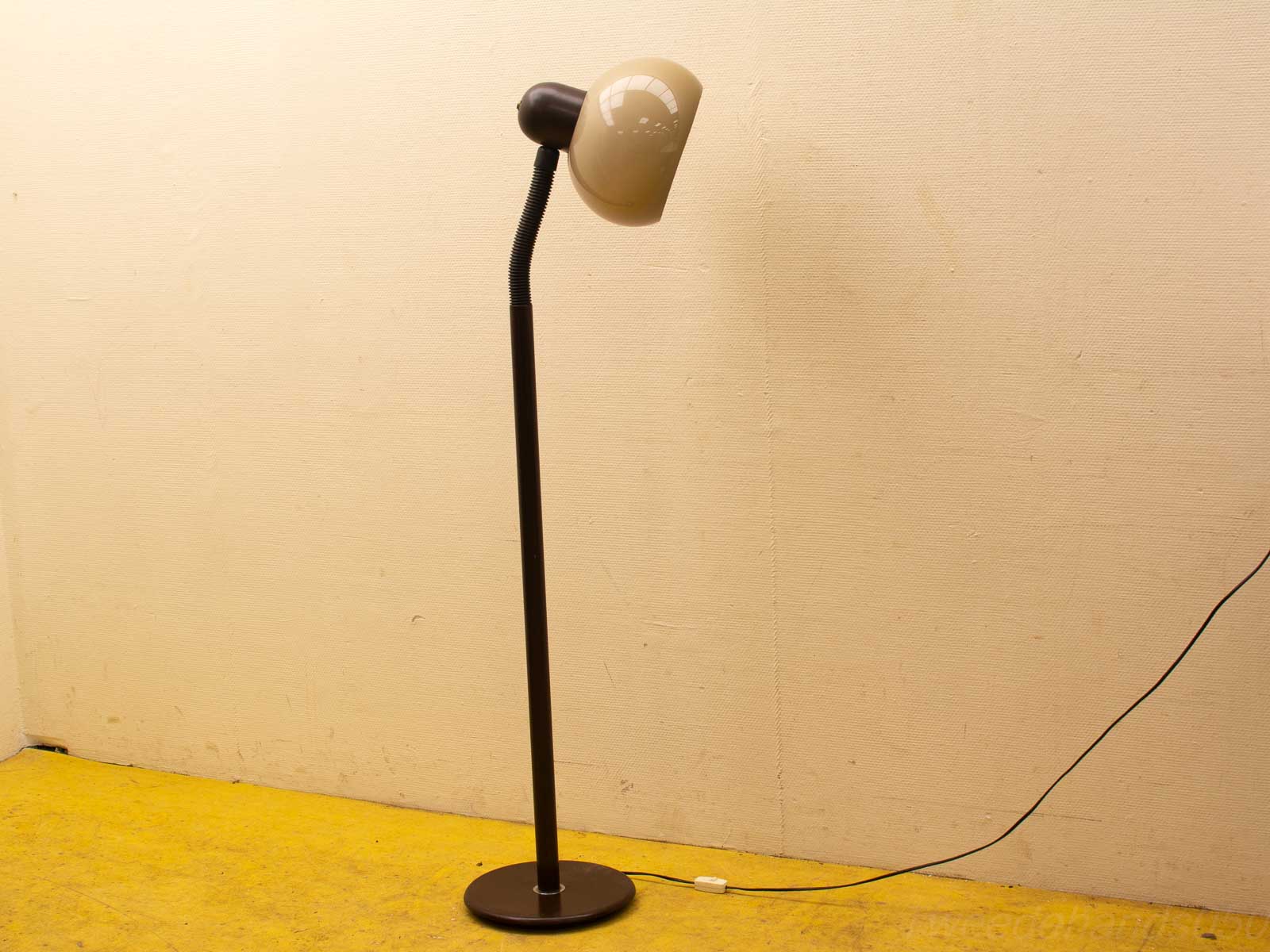 Contemporary floor lamp with adjustable neck and glossy shade, perfect for modern interiors.