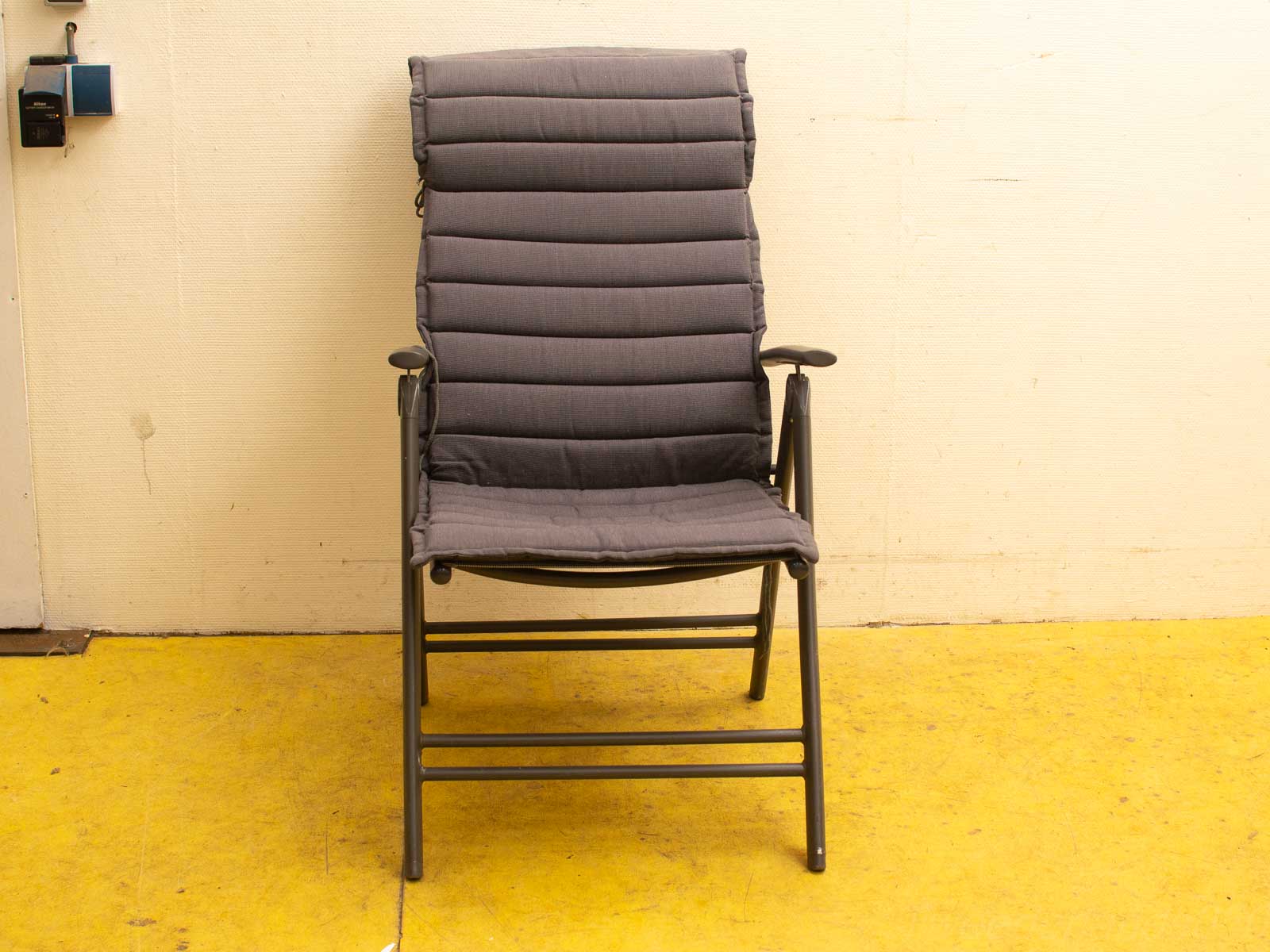 Stylish gray reclining chair with quilted fabric, perfect for relaxation in any setting.