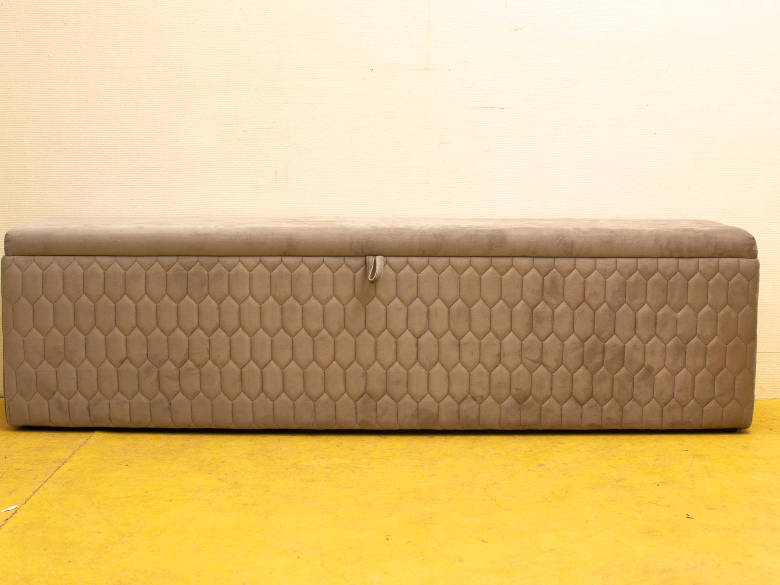 Modern taupe storage bench with hexagonal quilted pattern, perfect for contemporary decor and organization.