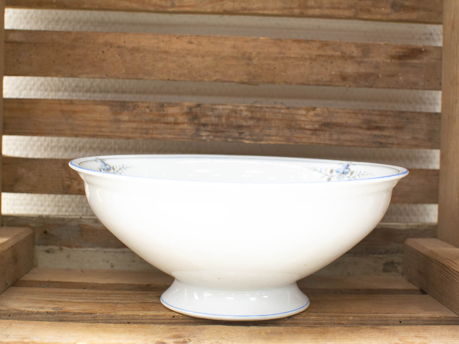 Elegant porcelain bowl with floral design, showcasing beauty against rustic wooden background.