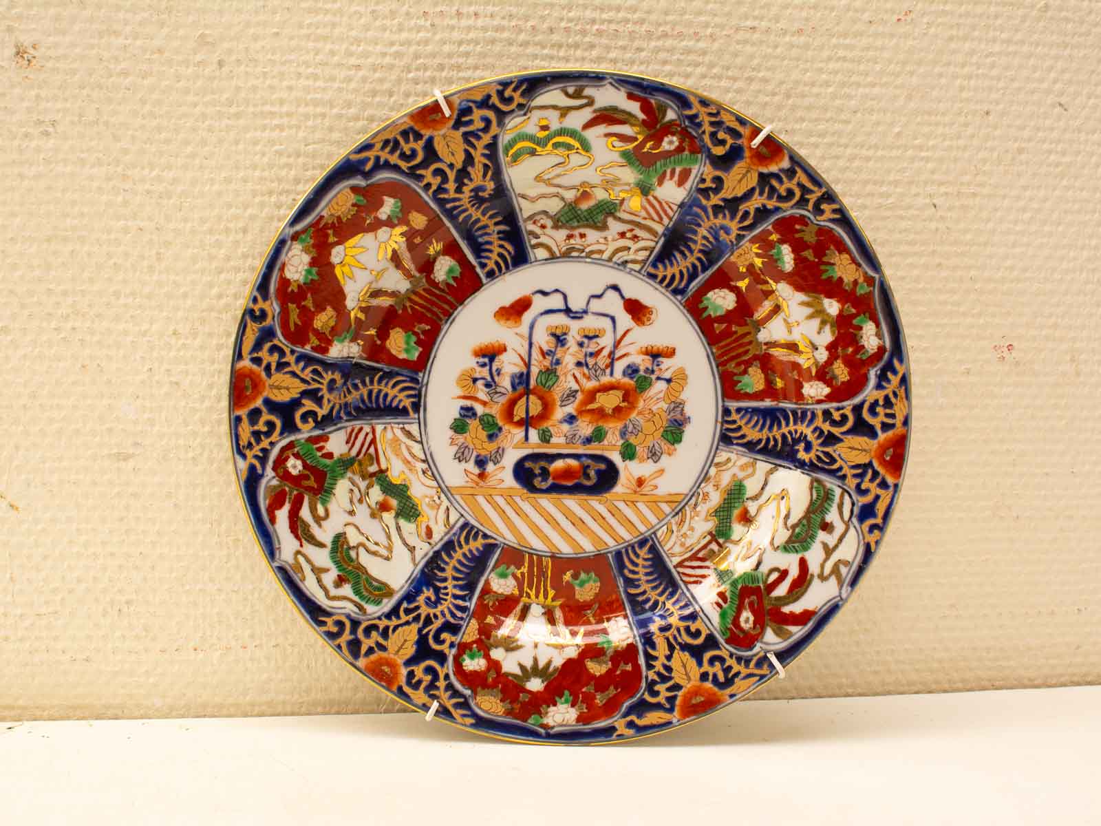 Exquisite decorative porcelain plate with vibrant floral motifs and elegant blue and gold accents.