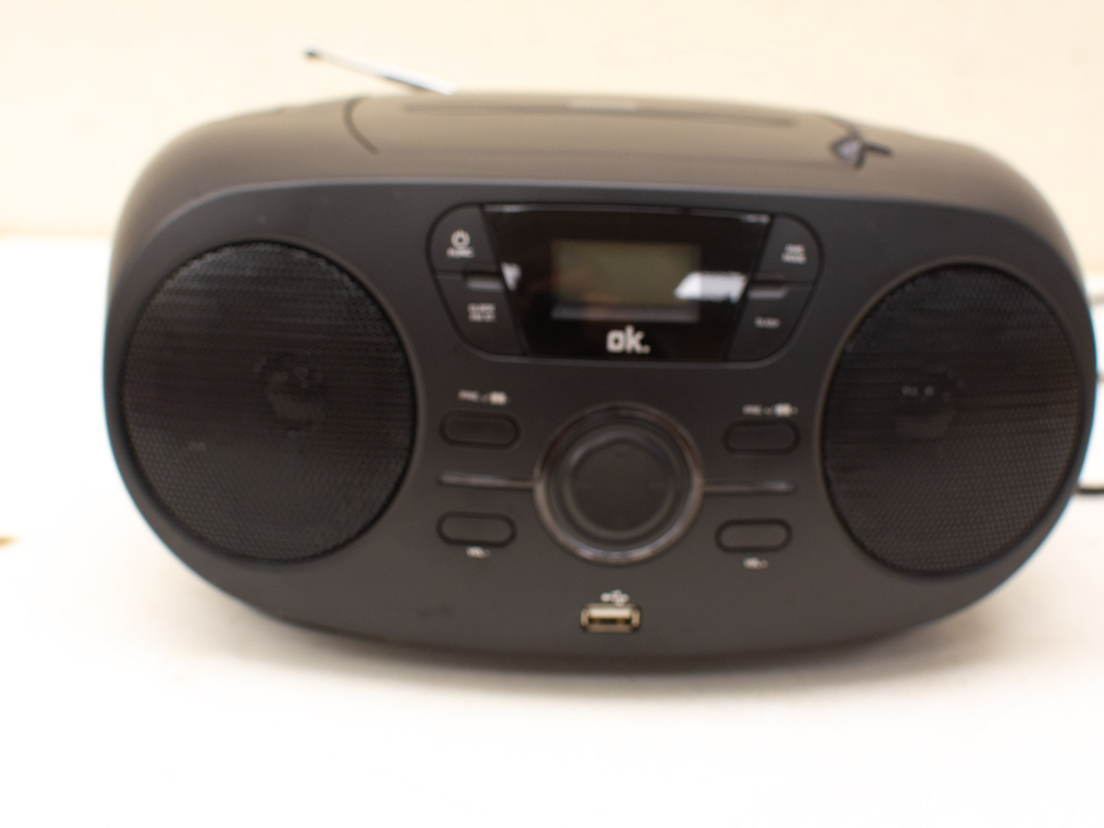 Sleek black portable boombox with modern features for music and radio playback.