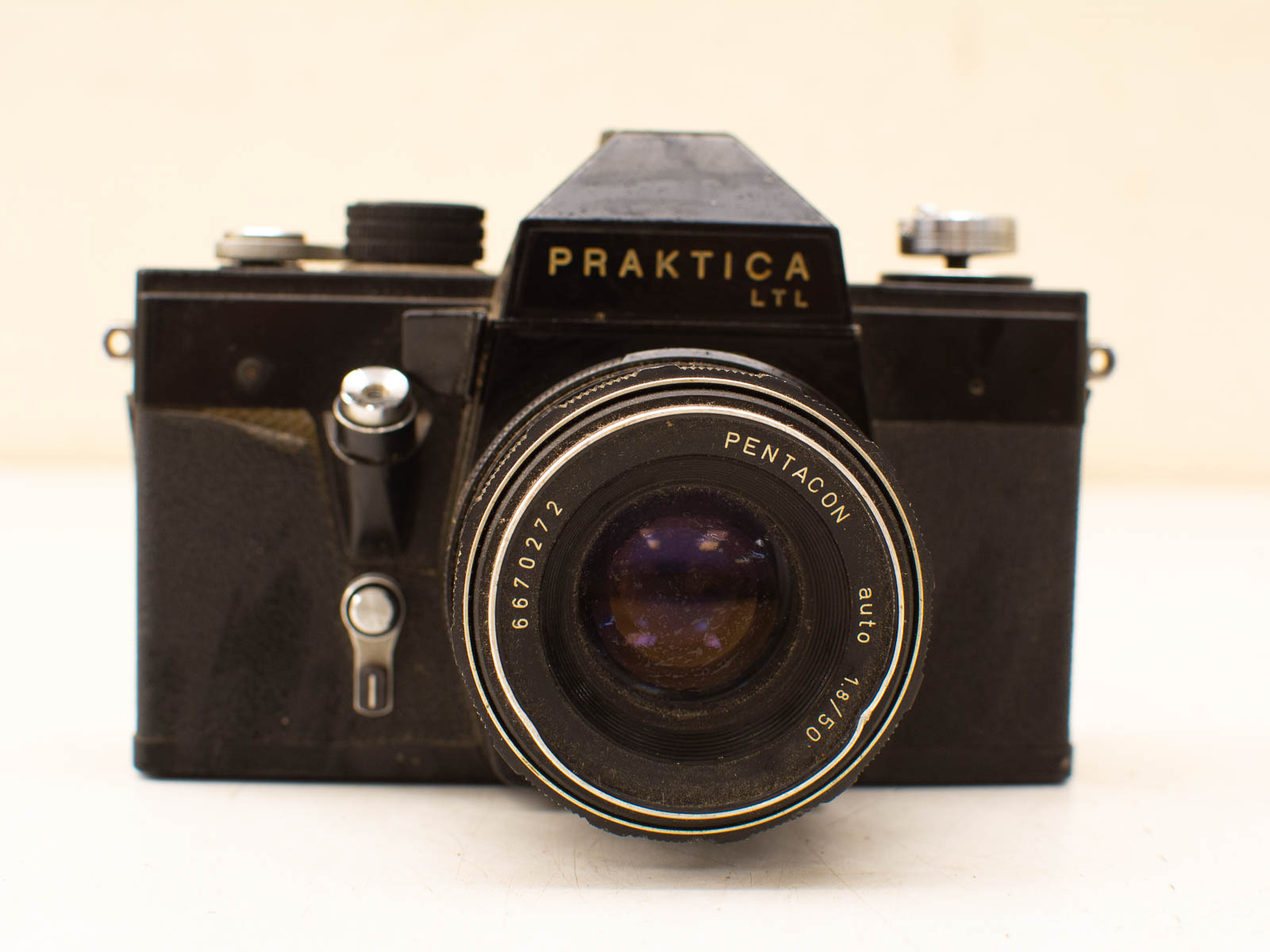 Vintage Praktica LTL camera with Pentacon f/1.8 lens, perfect for collectors and photography lovers.