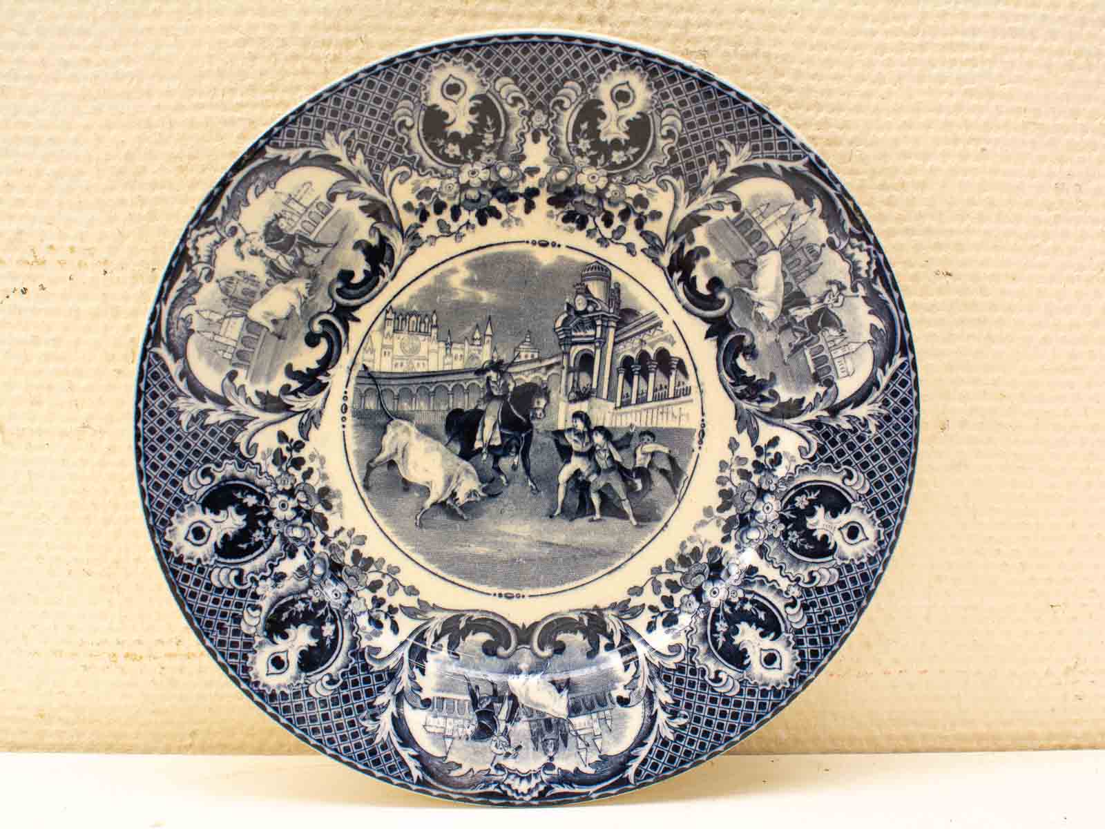 Blue and white decorative plate depicting a historical hunting scene with horse and dog.