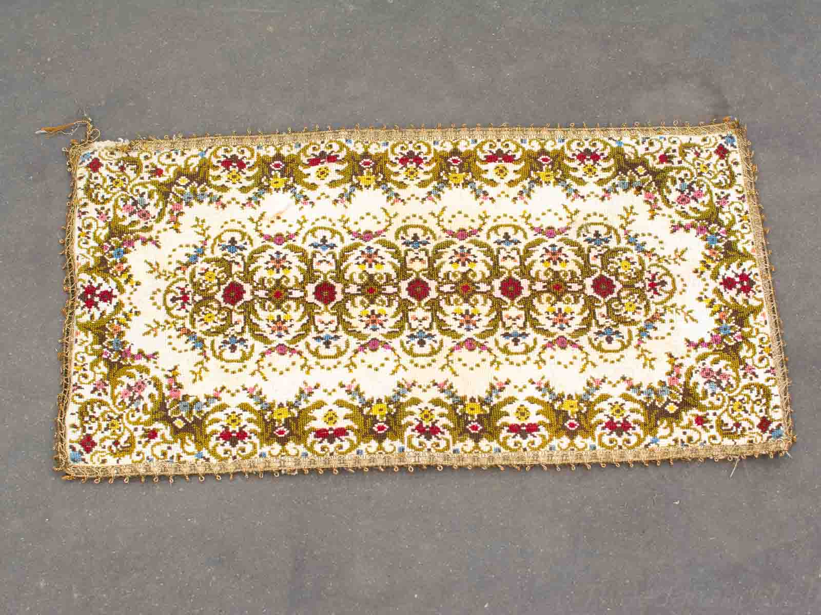 Vibrant handwoven rug with intricate floral patterns enhancing any decor with artisanal elegance.