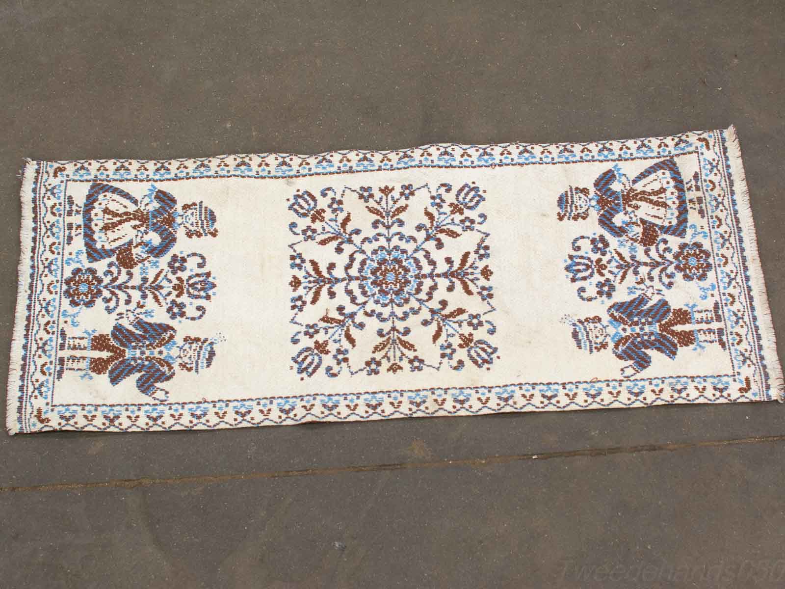 Vibrant vintage rug featuring floral patterns and traditional figures, perfect for adding cultural charm.