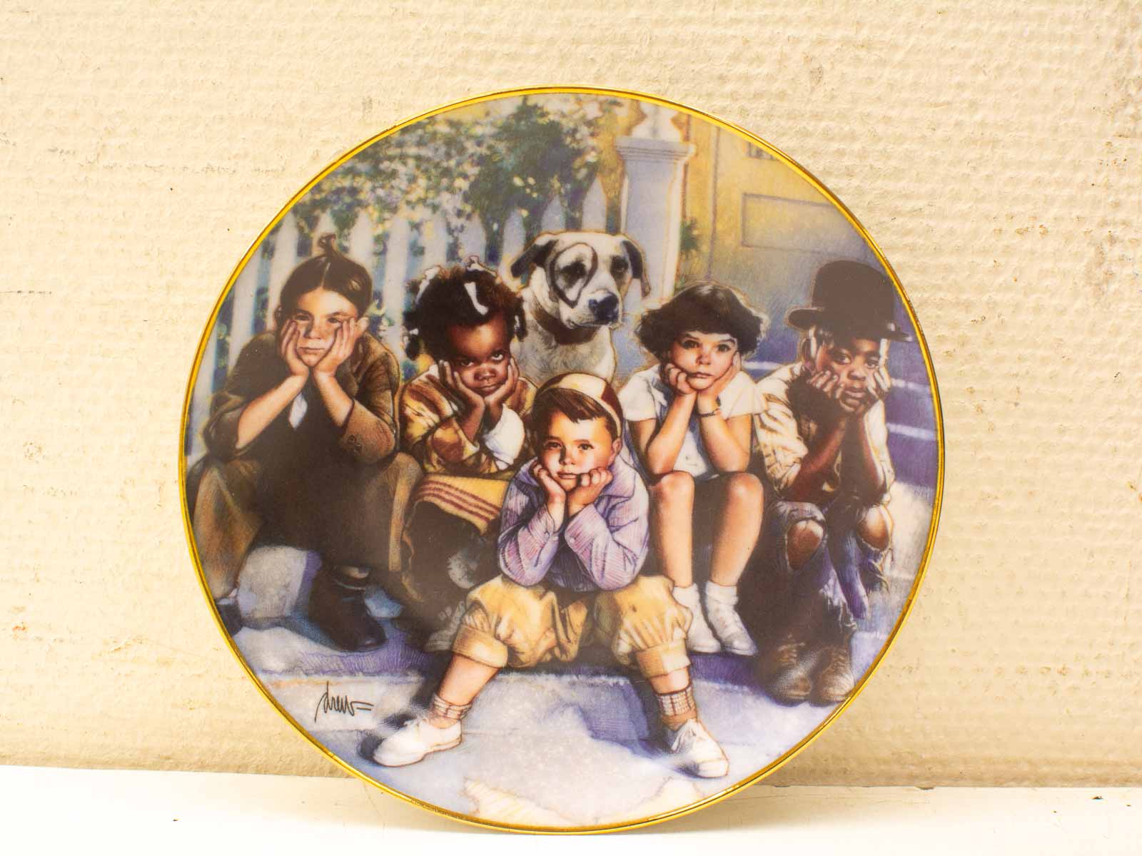 Charming vintage plate depicting children and a dog sharing playful moments on house steps.