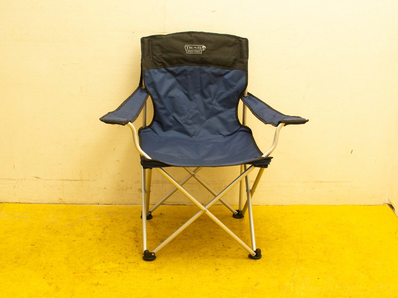 Stylish navy blue folding camping chair with durable aluminum frame and comfortable armrests.