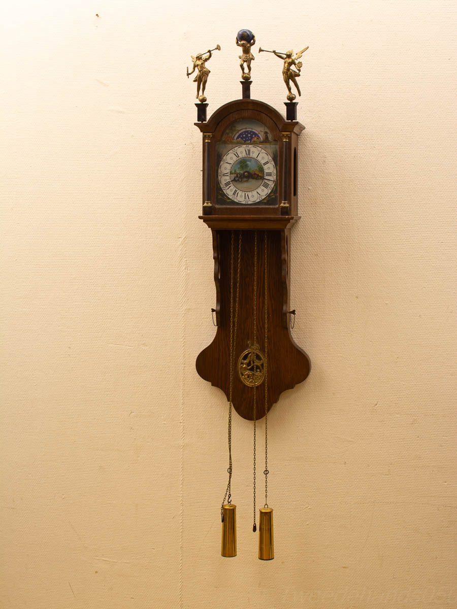 Elegant vintage wall clock with ornate figures and a colorful dial, perfect for any decor.