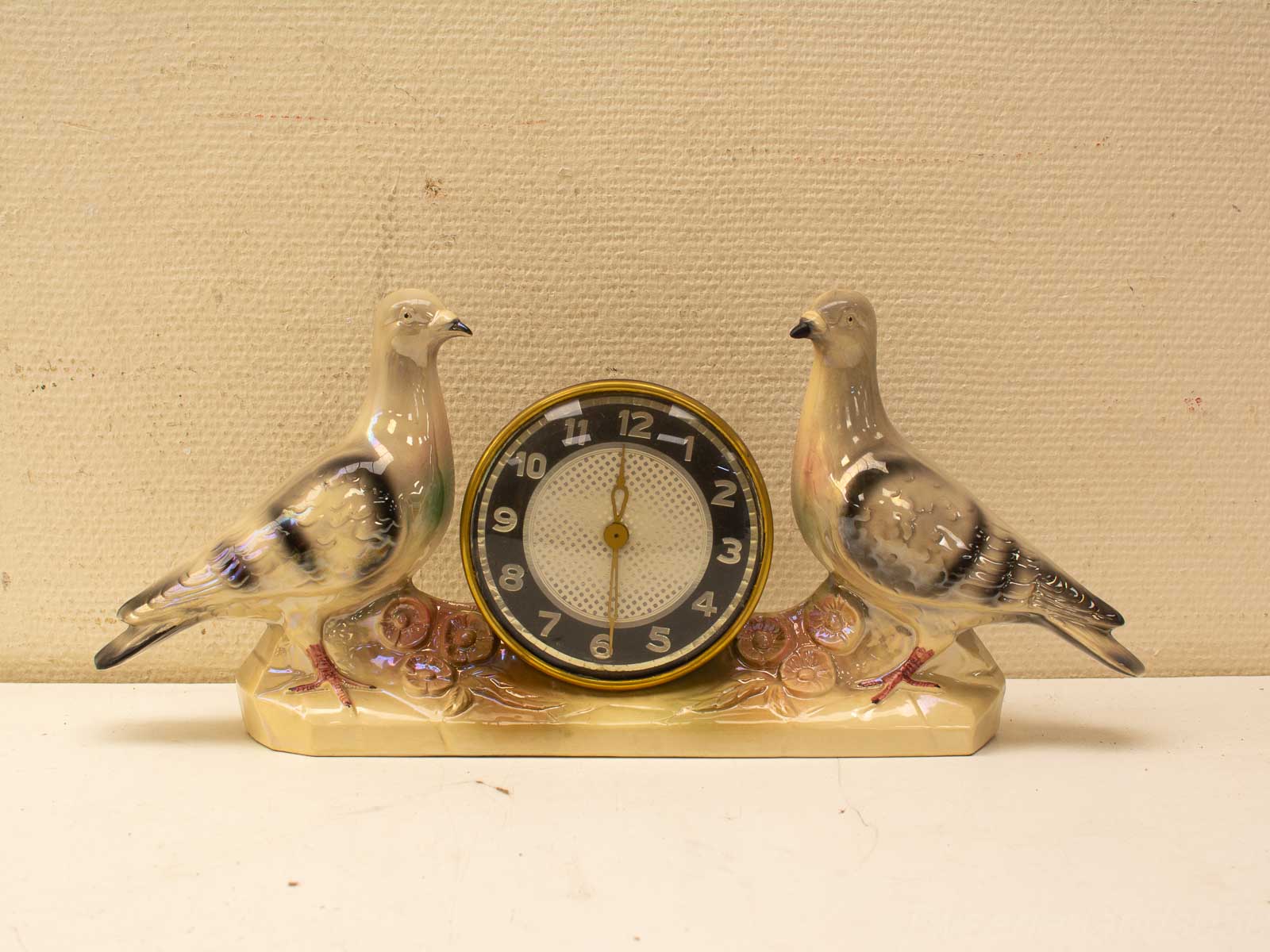 Charming vintage clock with ceramic birds, elegant design, perfect for home decor enthusiasts.