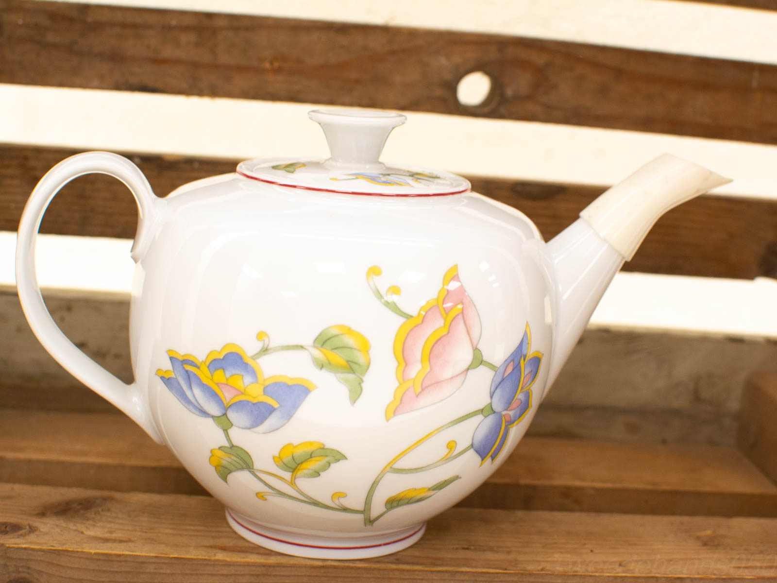 Elegant vintage porcelain teapot with vibrant floral design, perfect for tea service and home decor.