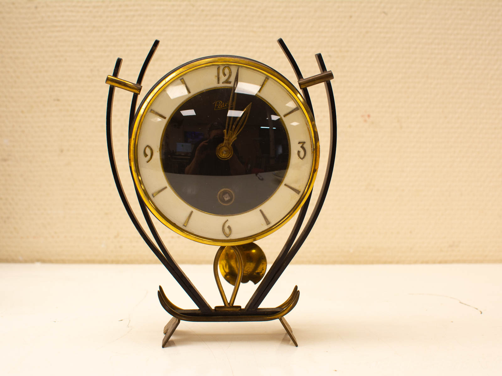 Elegant vintage tabletop clock with gold accents and glossy black face for timeless charm.