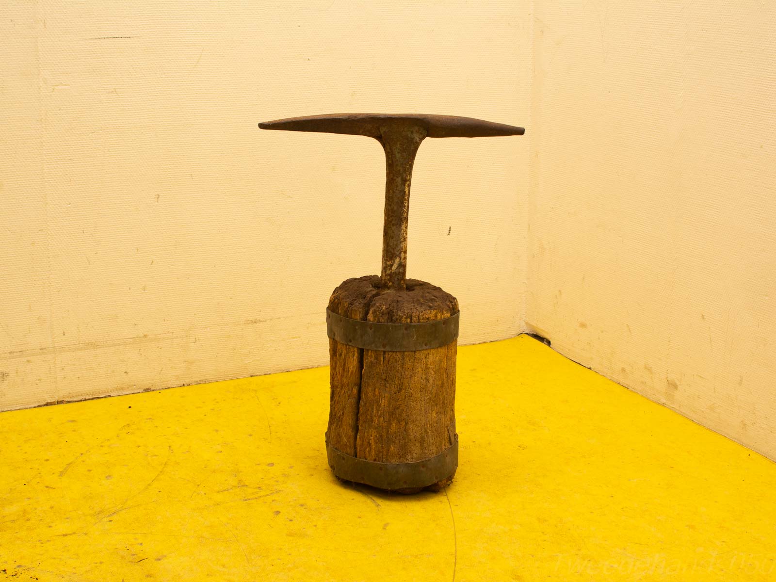 Vintage wooden craft tool with metal top, showcasing rustic charm and artisanal history.