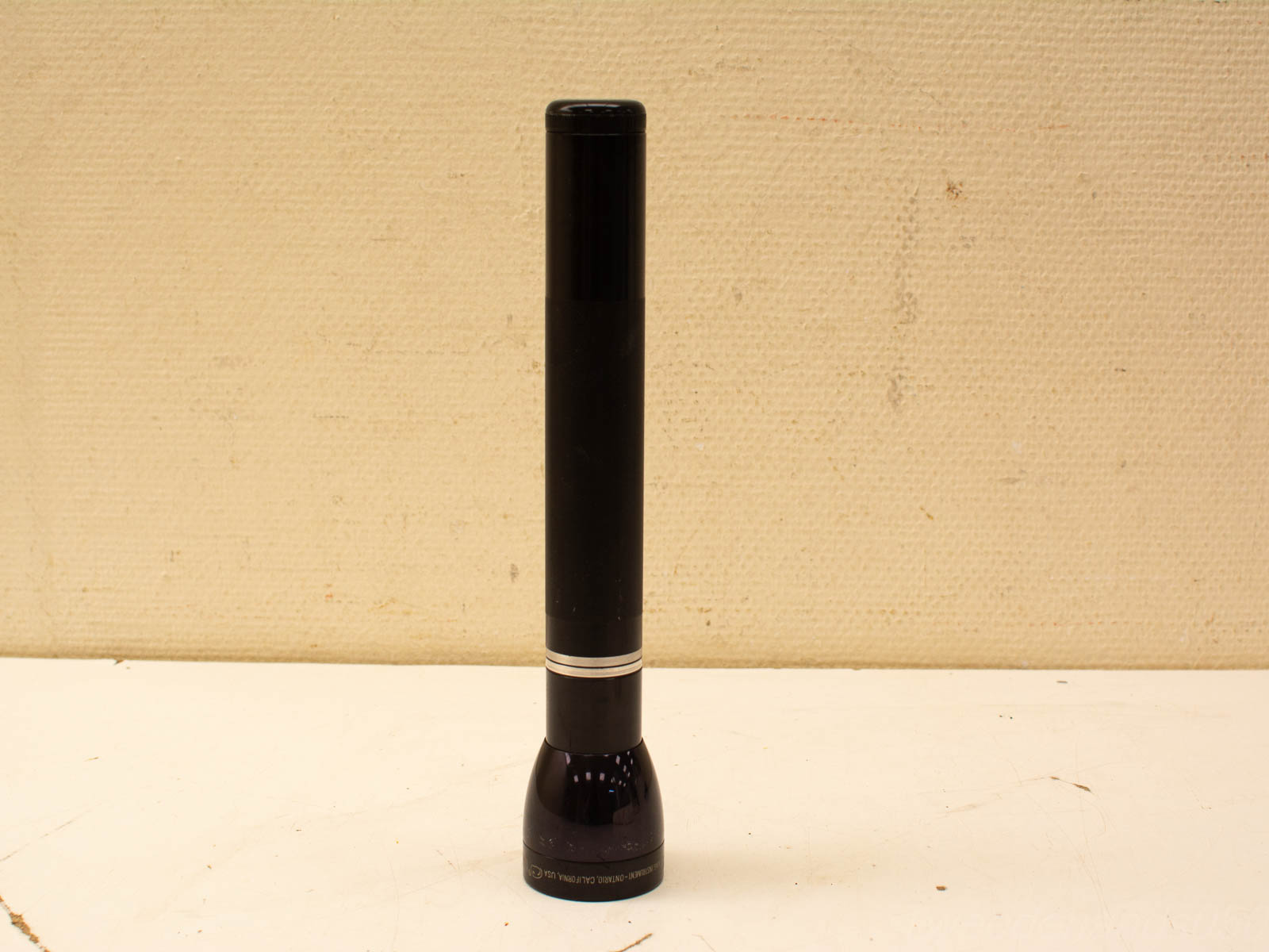 Sleek black flashlight with glossy finish, ideal for outdoor use and emergencies.