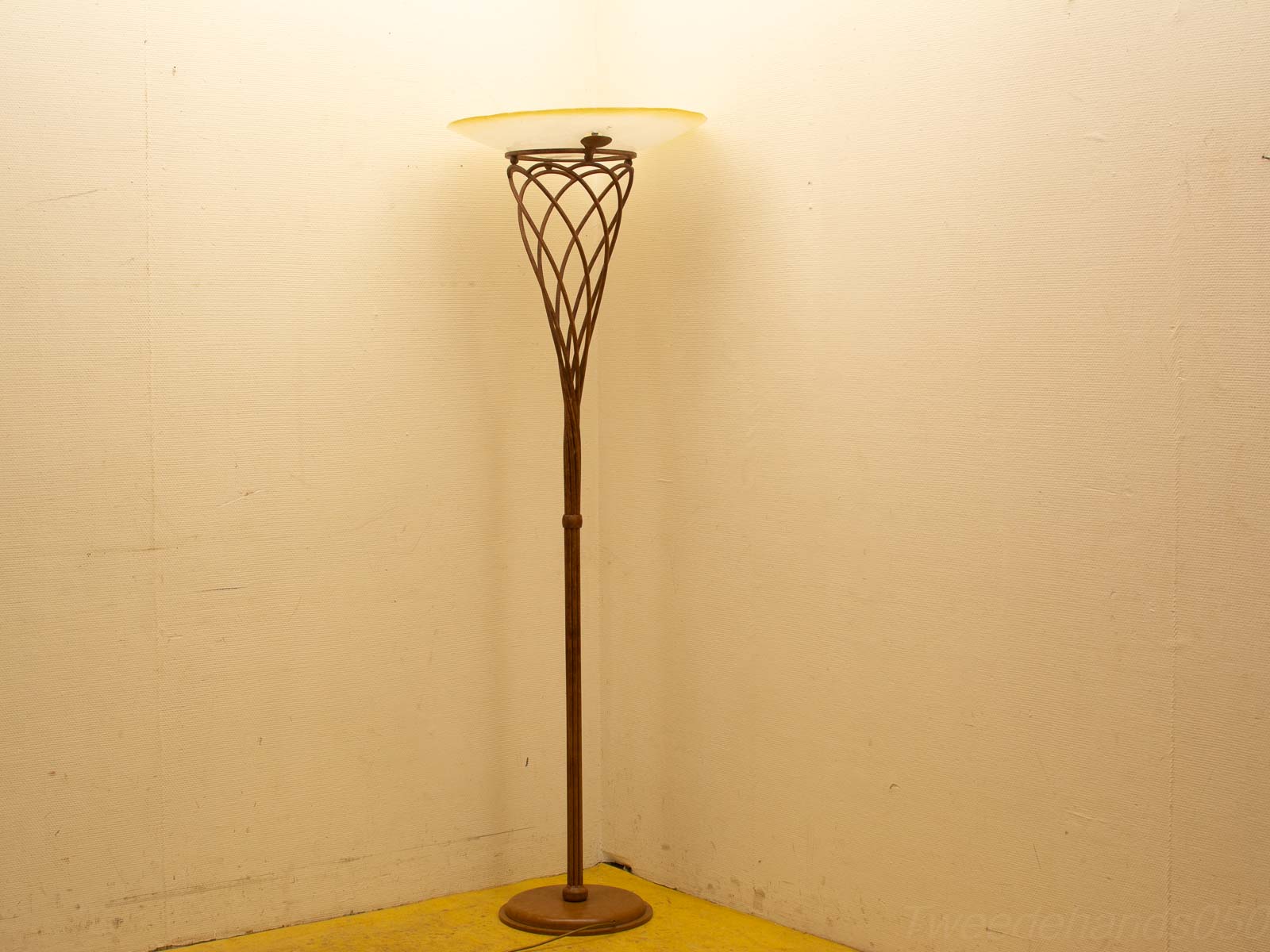 Elegant vintage floor lamp with slender metal base and frosted glass shade, perfect for cozy decor.