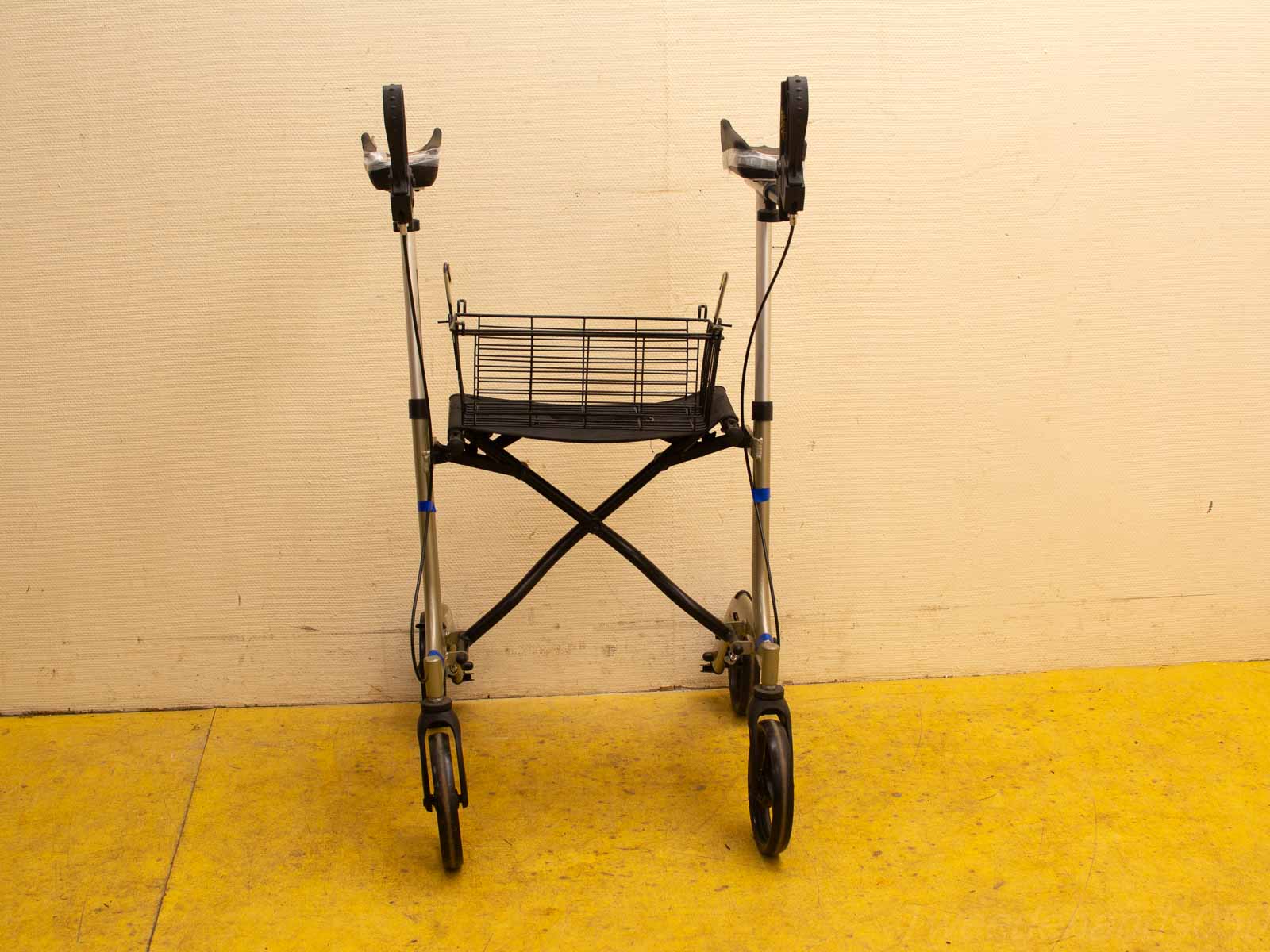 Compact wheeled walker with adjustable handlebars and basket for enhanced mobility and convenience.