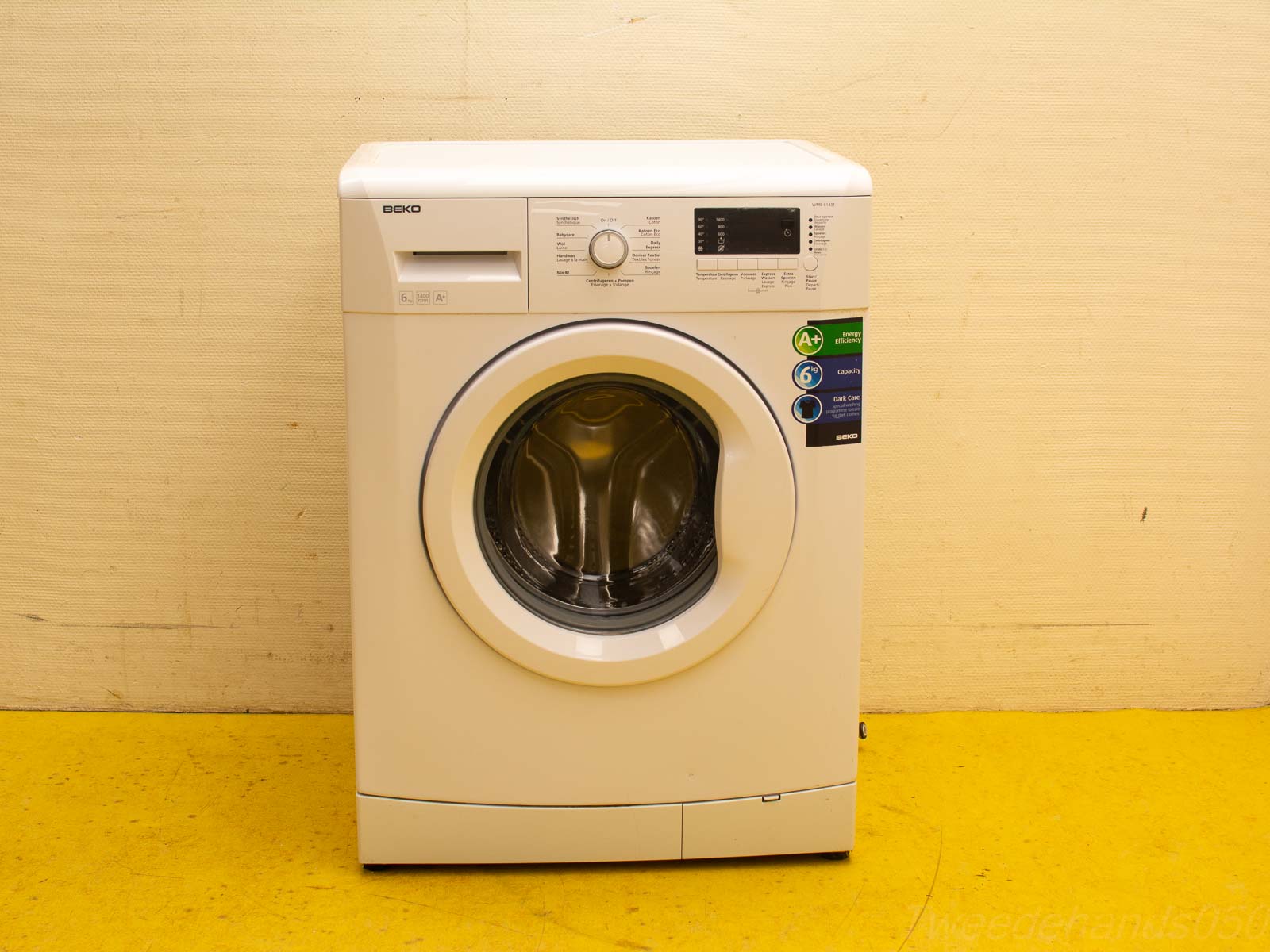 Modern white front-loading washing machine with A+ energy label and user-friendly controls.