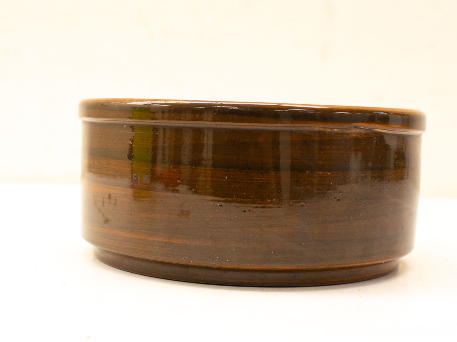 Handmade dark brown ceramic bowl with glossy finish, perfect for serving or décor.